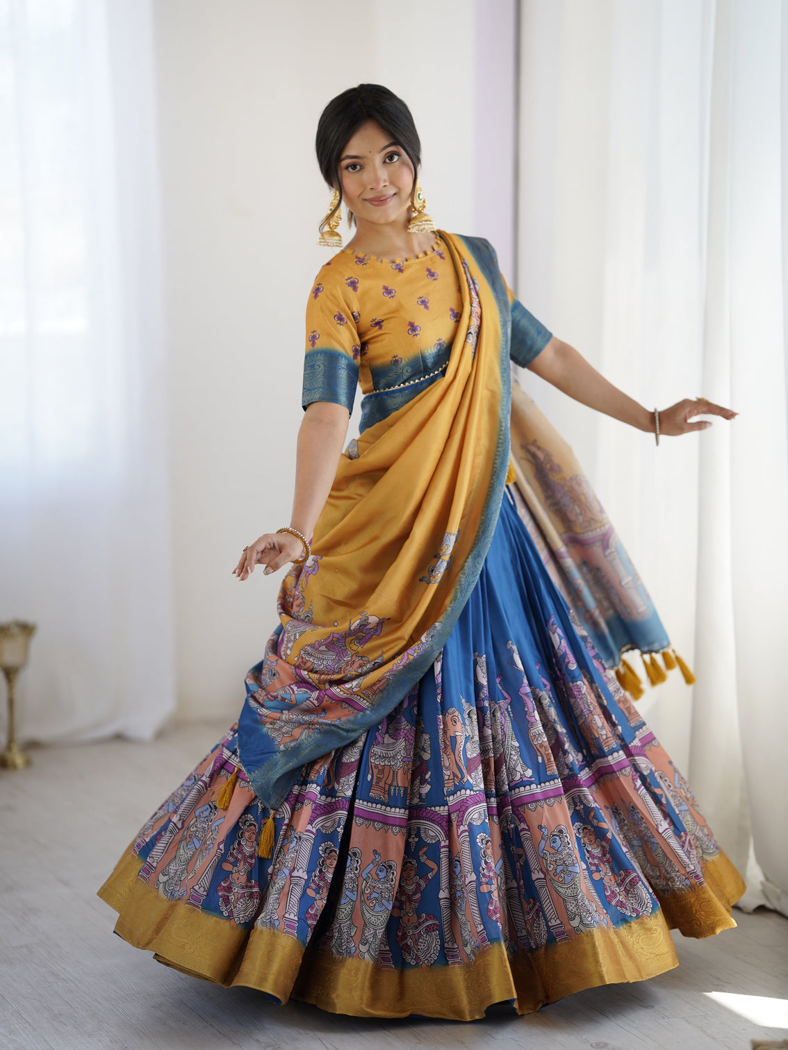 Elegant kalamkari lehenga in mustard and royal blue with flared skirt and dupatta