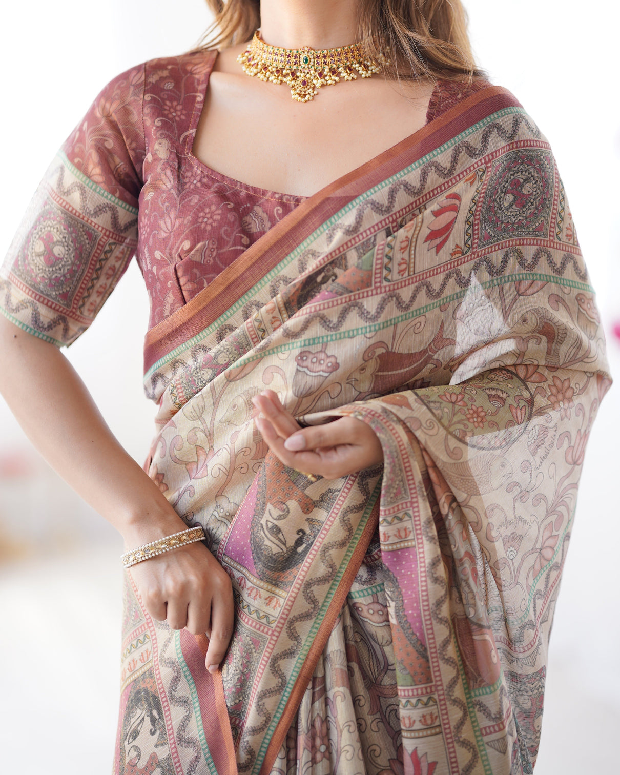 Beige maroon handloom cotton saree with royal faces elephant pallu motif