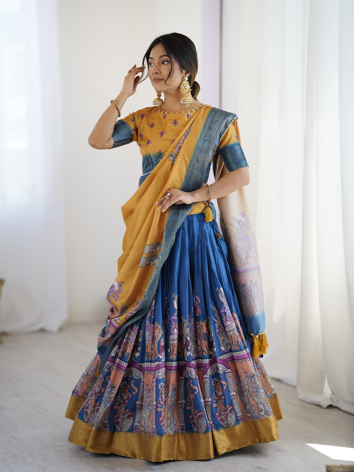 Elegant kalamkari lehenga in mustard and royal blue with flared skirt and dupatta