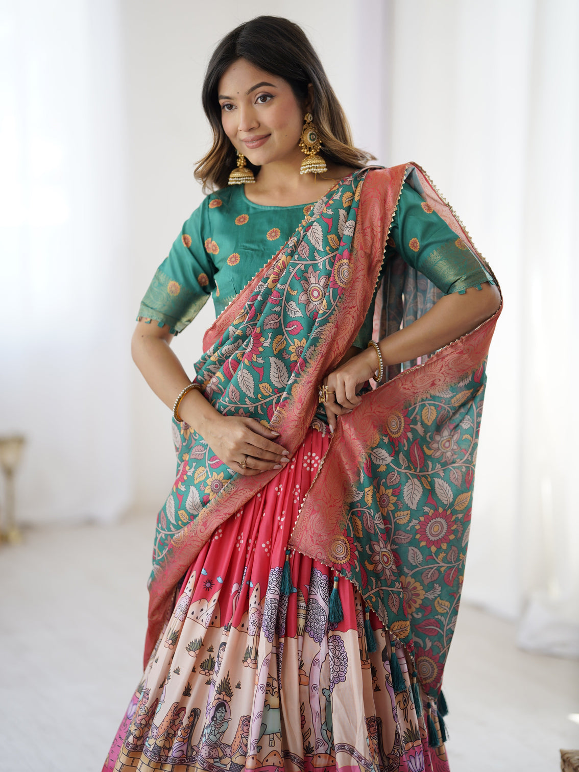 Elegant kalamkari lehenga in rani pink and teal green with mythological print and floral dupatta