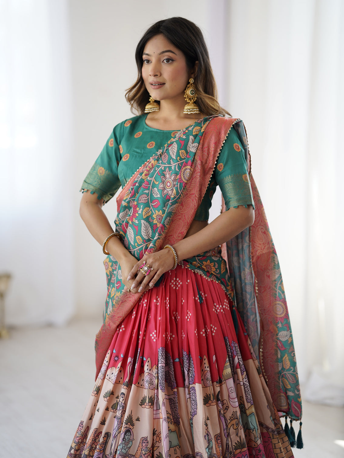 Elegant kalamkari lehenga in rani pink and teal green with mythological print and floral dupatta