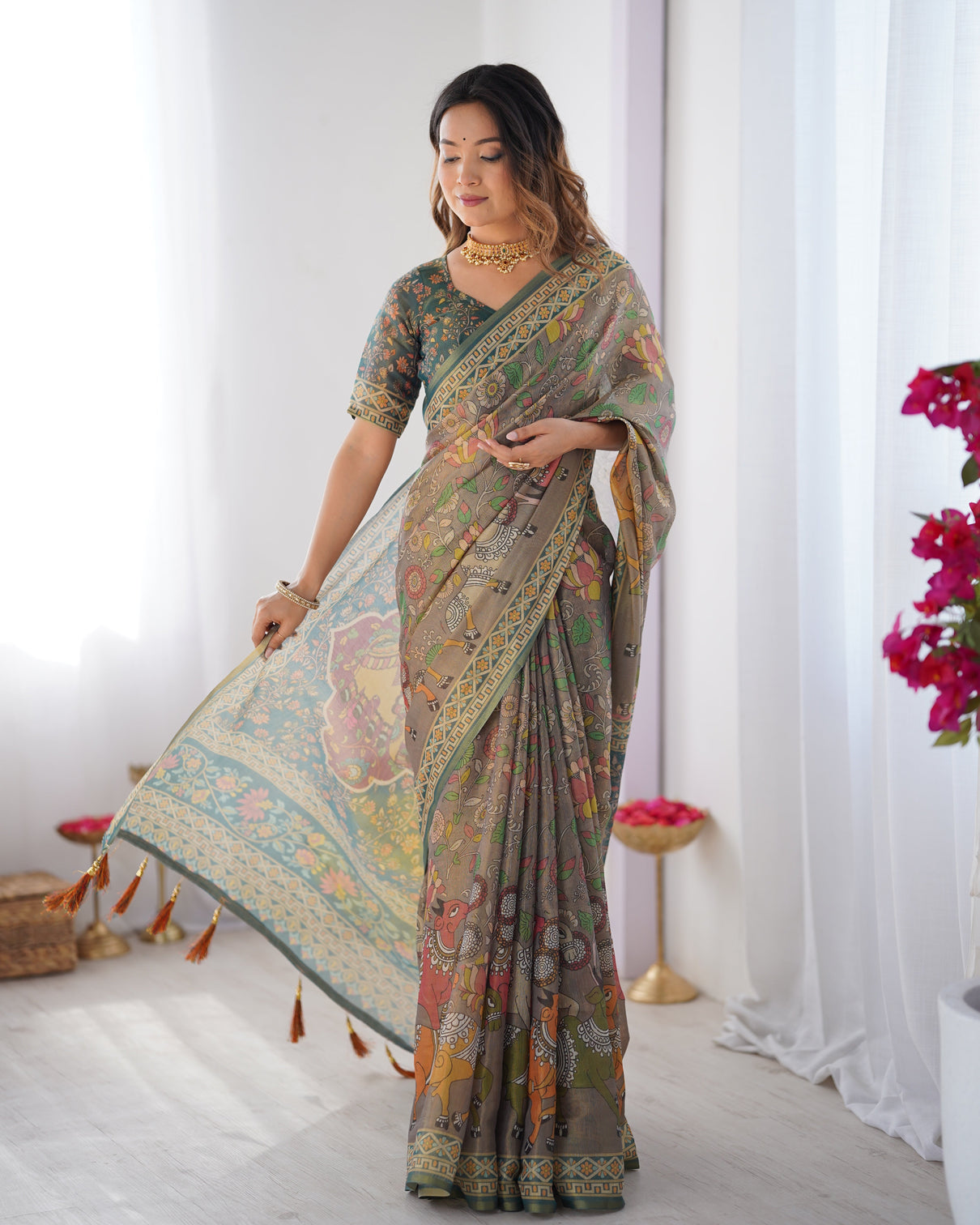 Teal green handloom cotton saree with floral print and royal elephant pallu