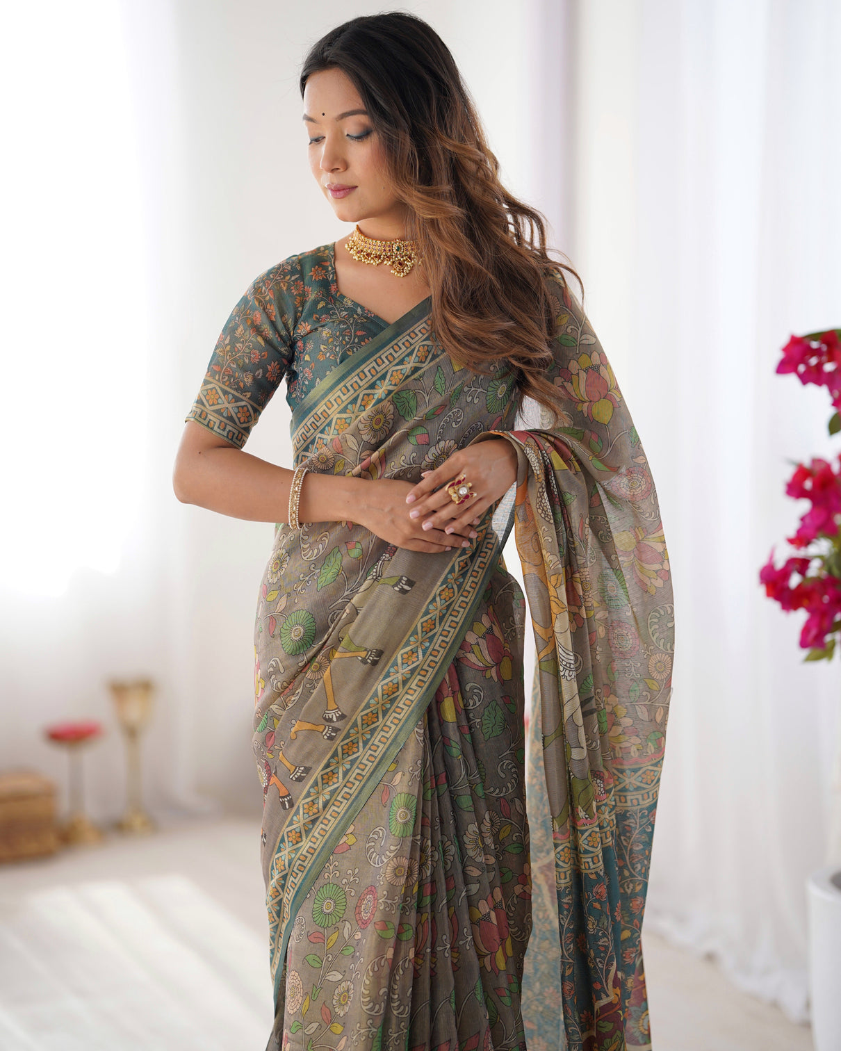 Teal green handloom cotton saree with floral print and royal elephant pallu