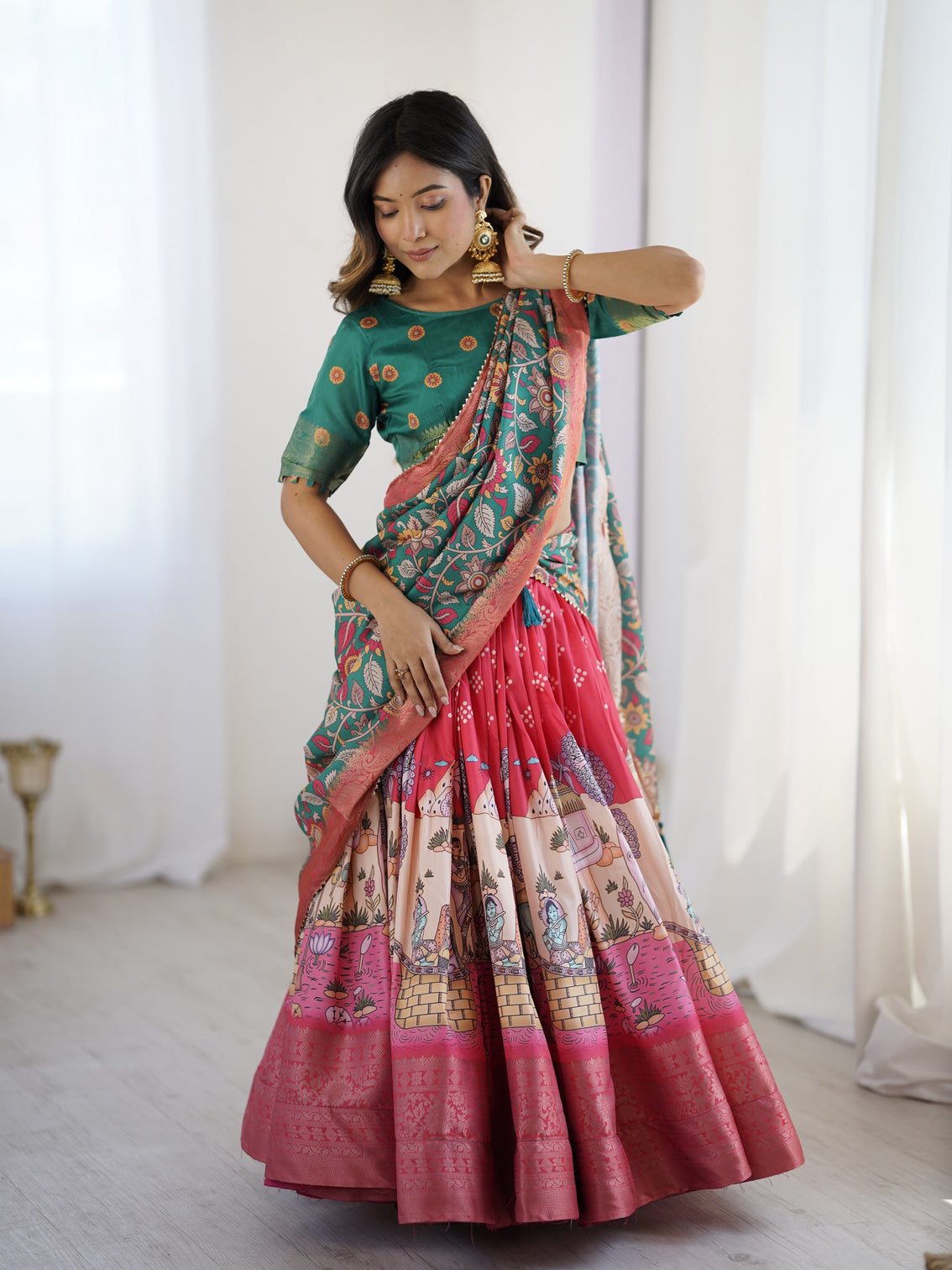 Elegant kalamkari lehenga in rani pink and teal green with mythological print and floral dupatta