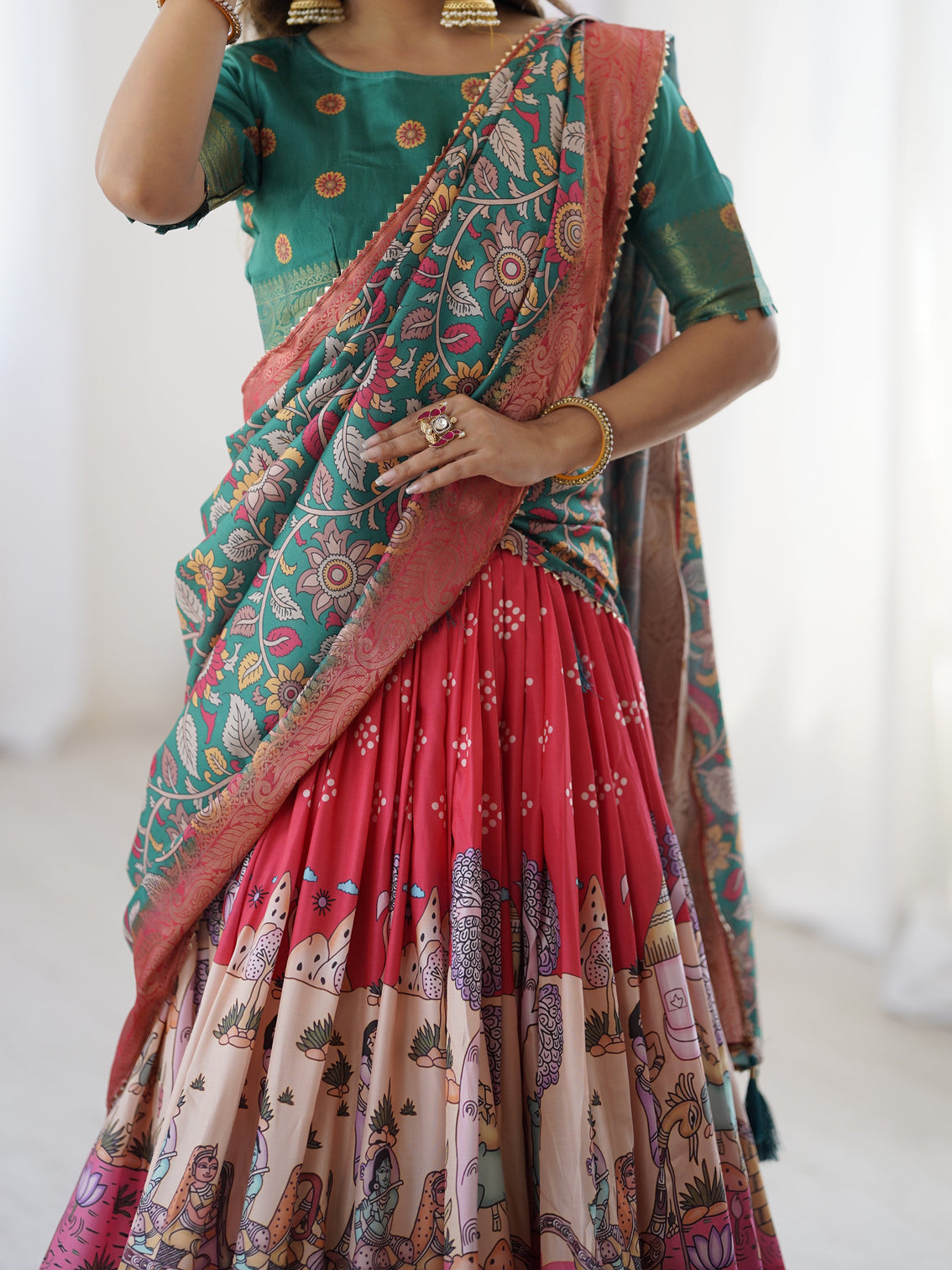 Elegant kalamkari lehenga in rani pink and teal green with mythological print and floral dupatta