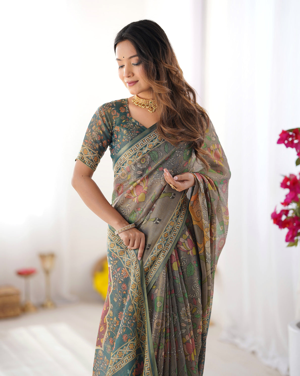 Teal green handloom cotton saree with floral print and royal elephant pallu