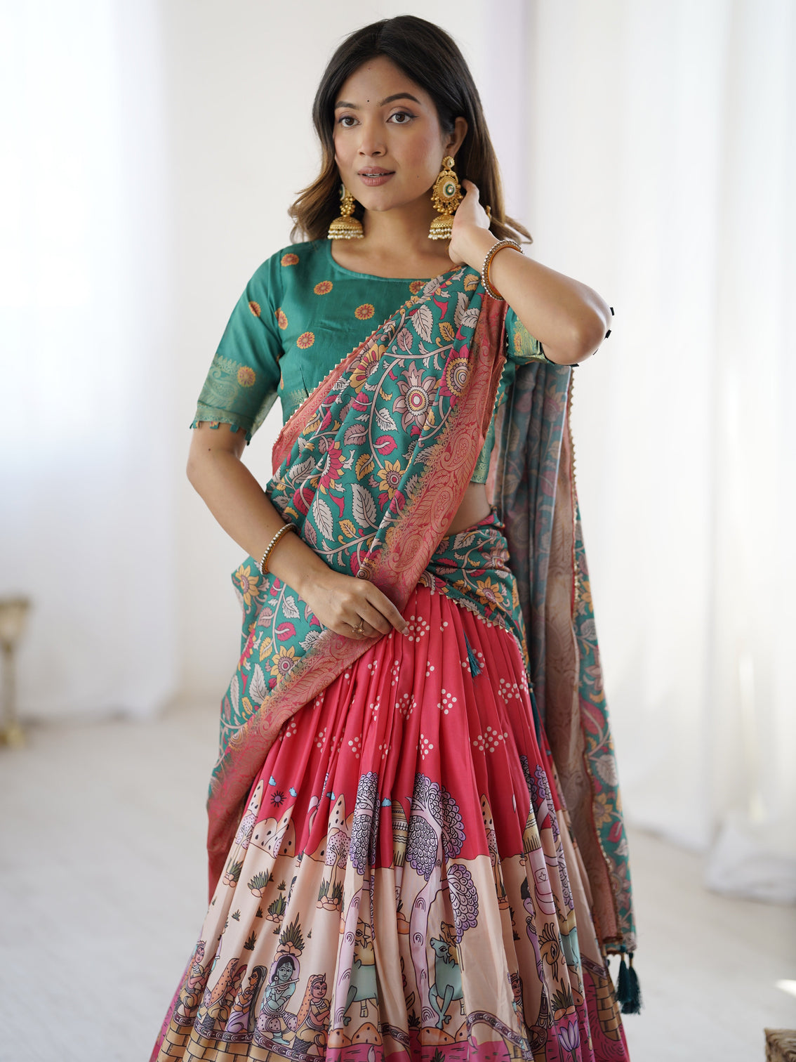 Elegant kalamkari lehenga in rani pink and teal green with mythological print and floral dupatta