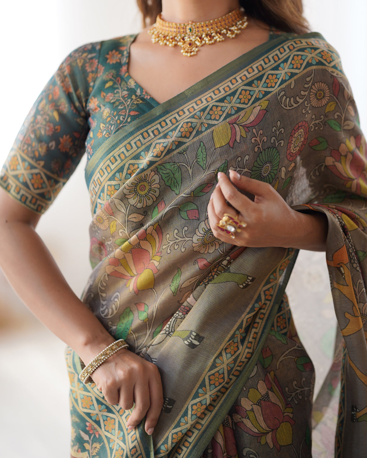 Teal green handloom cotton saree with floral print and royal elephant pallu