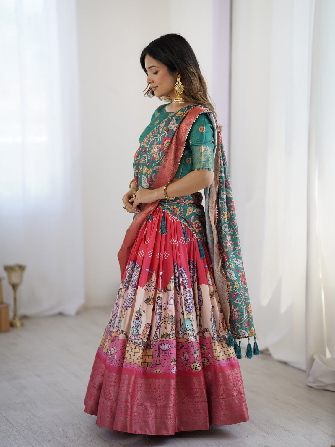 Elegant kalamkari lehenga in rani pink and teal green with mythological print and floral dupatta