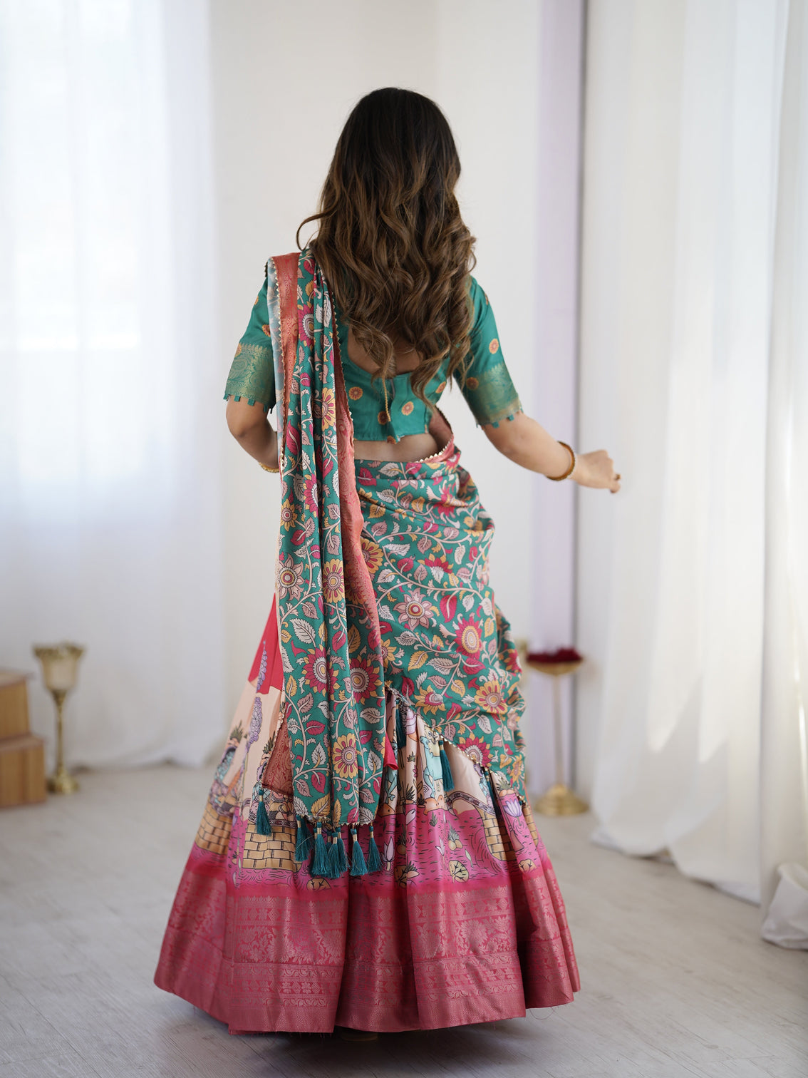 Elegant kalamkari lehenga in rani pink and teal green with mythological print and floral dupatta