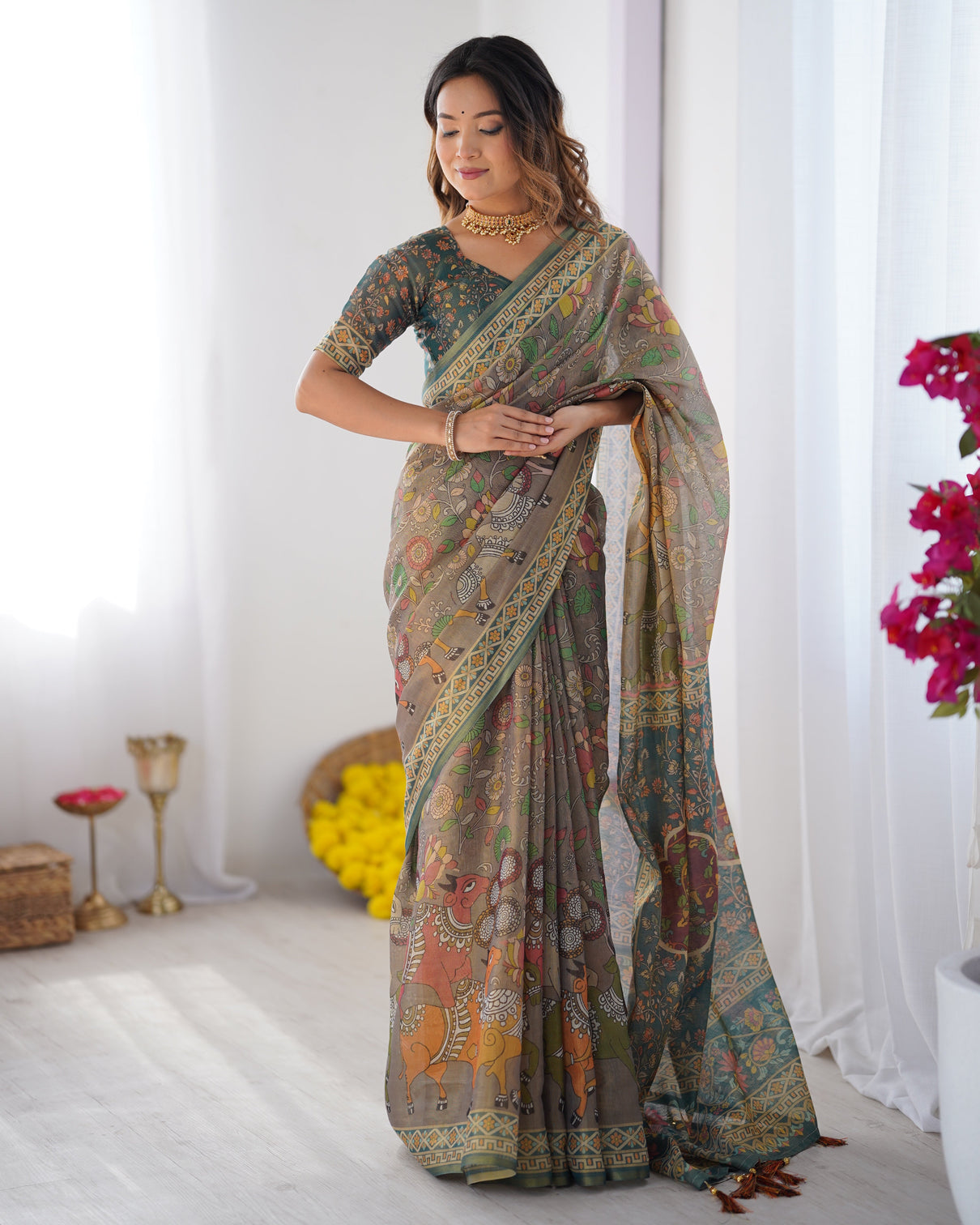 Teal green handloom cotton saree with floral print and royal elephant pallu