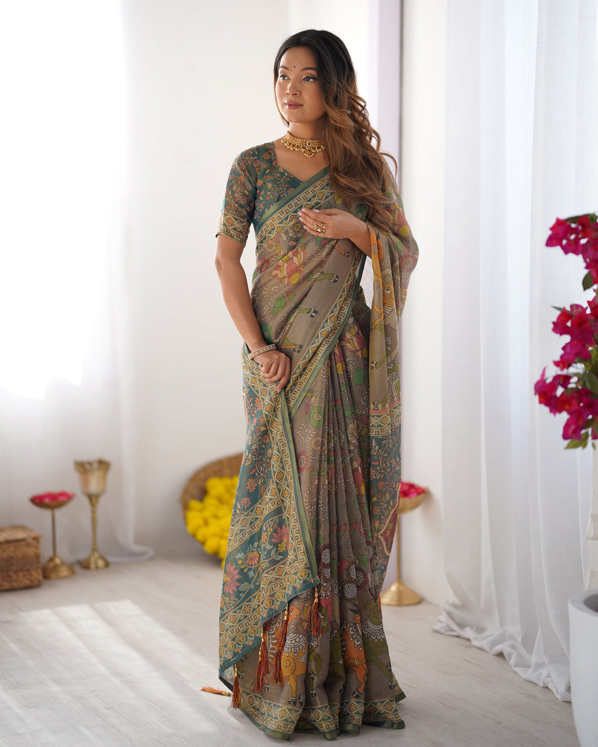 Teal green handloom cotton saree with floral print and royal elephant pallu