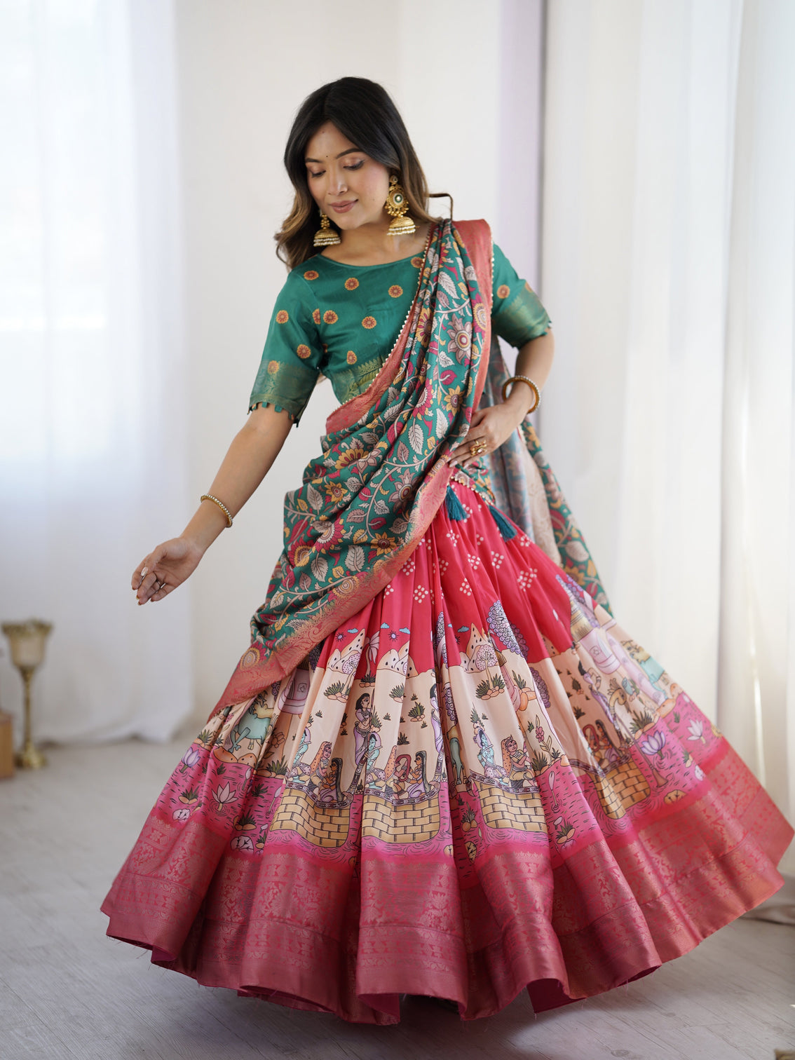 Elegant kalamkari lehenga in rani pink and teal green with mythological print and floral dupatta