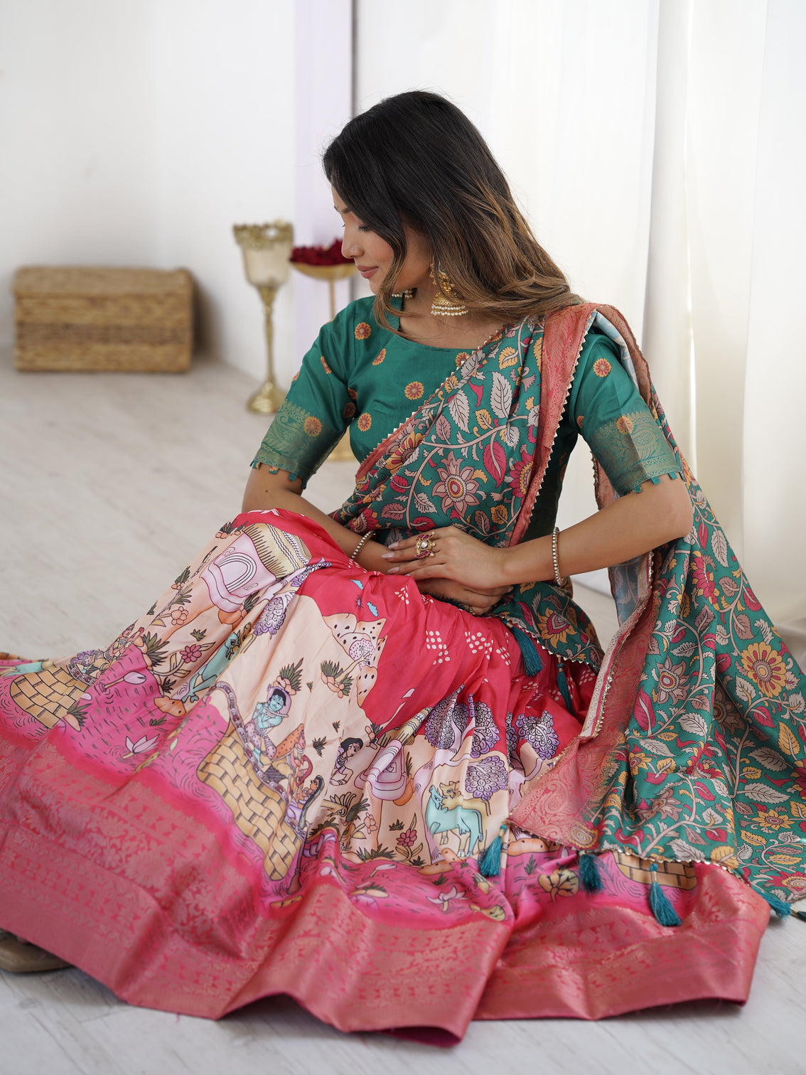 Elegant kalamkari lehenga in rani pink and teal green with mythological print and floral dupatta