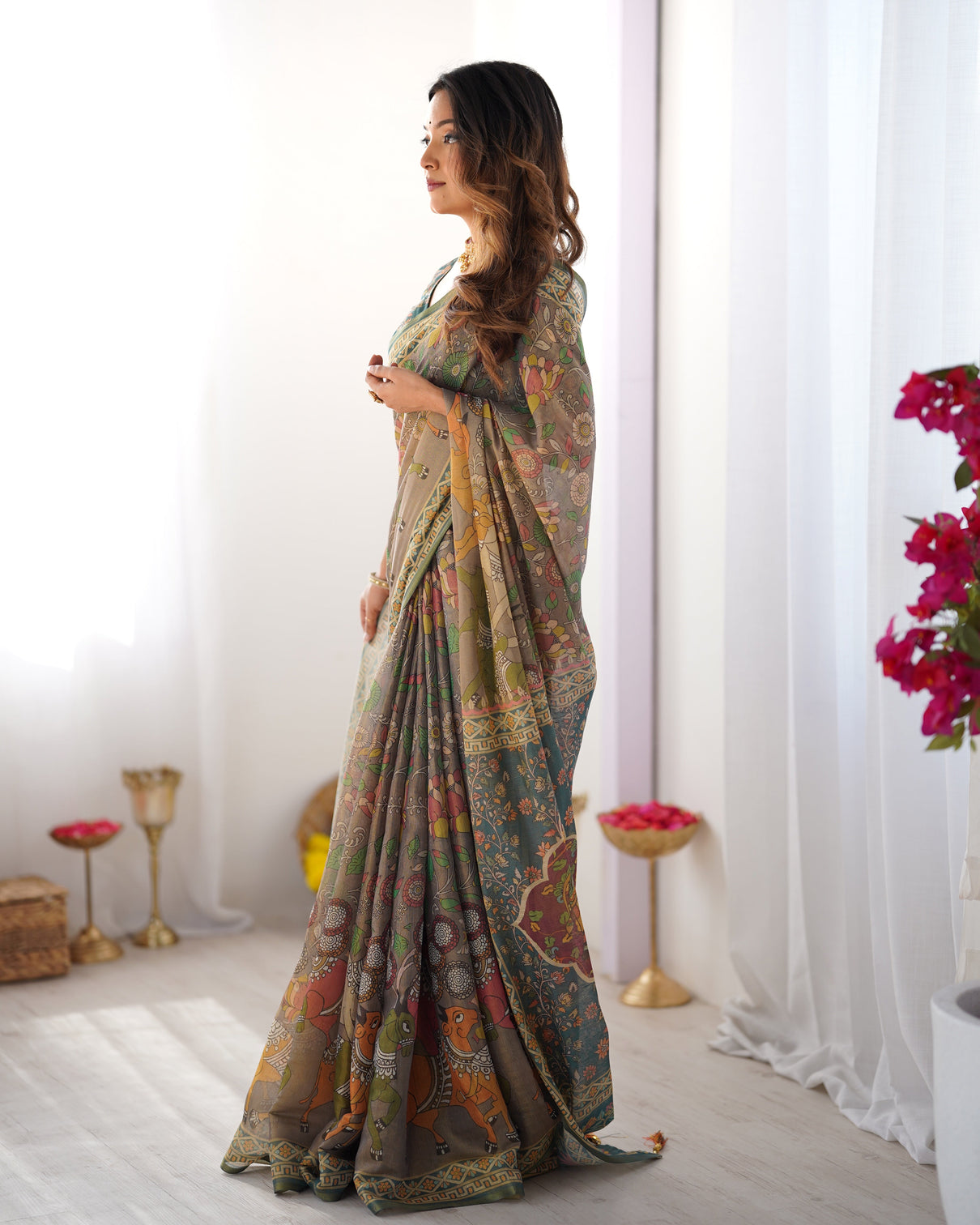 Teal green handloom cotton saree with floral print and royal elephant pallu