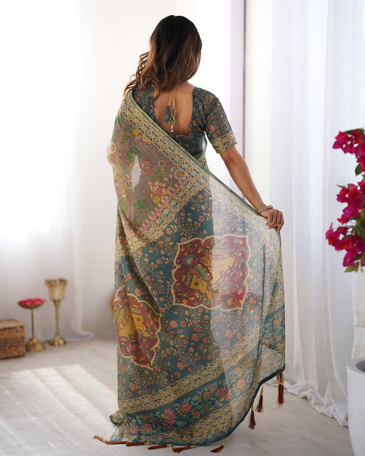 Teal green handloom cotton saree with floral print and royal elephant pallu