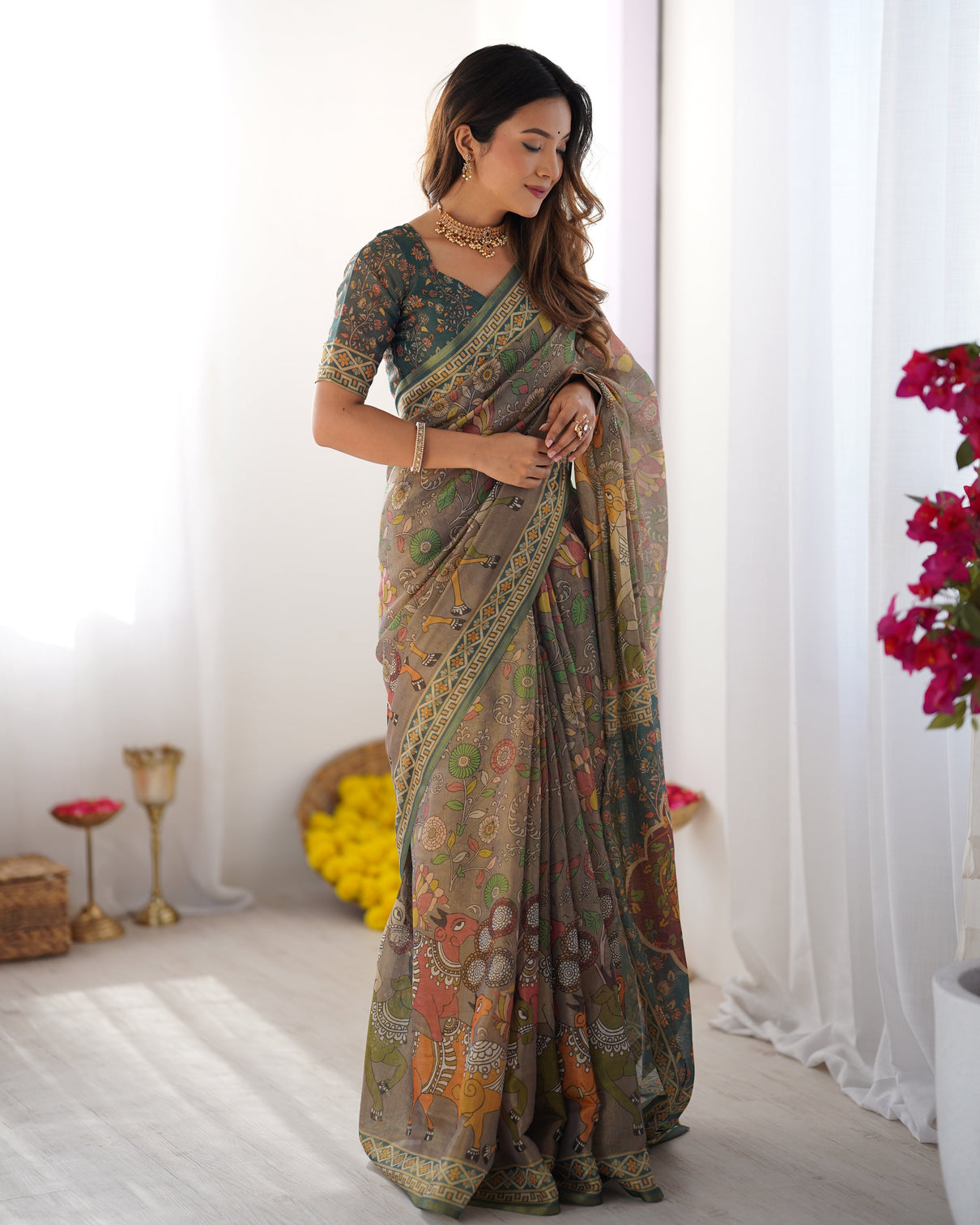 Teal green handloom cotton saree with floral print and royal elephant pallu