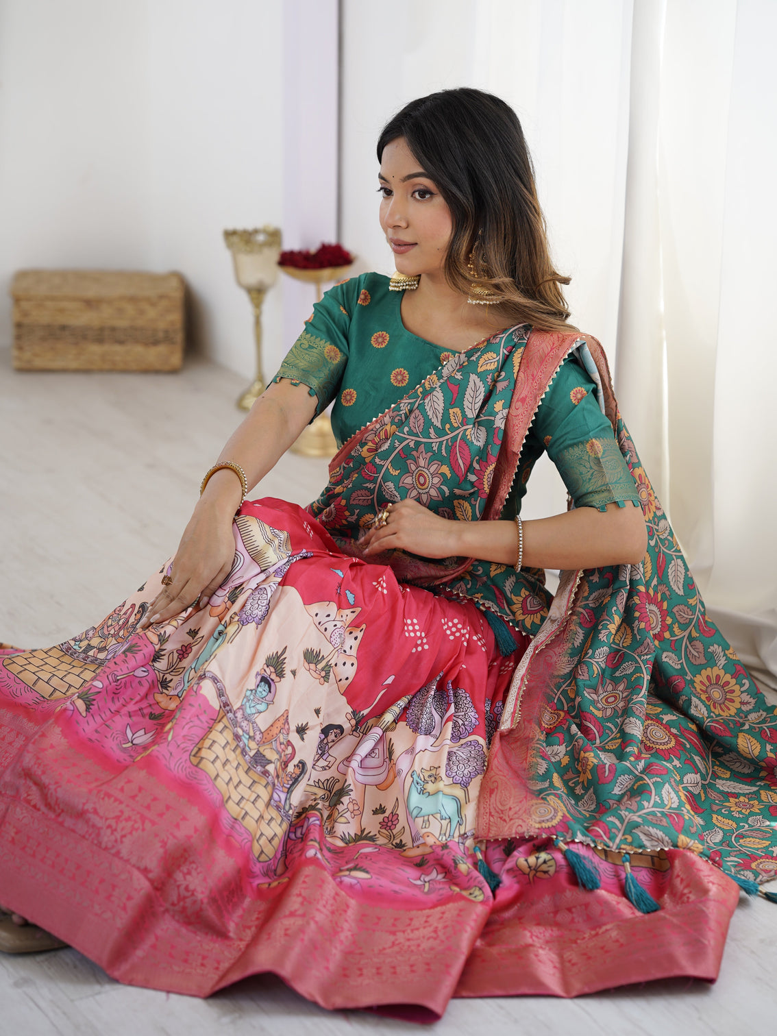 Elegant kalamkari lehenga in rani pink and teal green with mythological print and floral dupatta