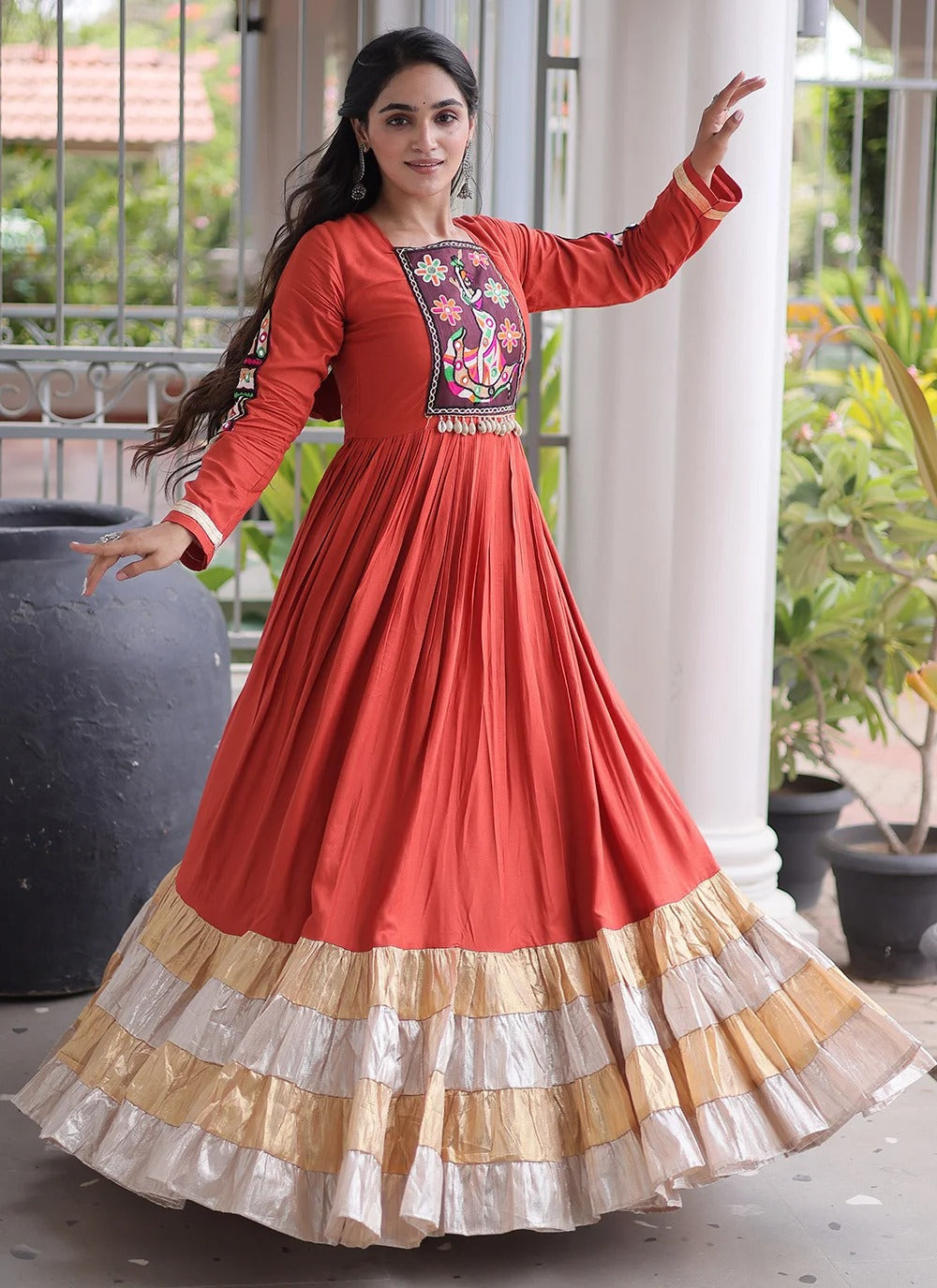 Rust color navratri gown with kutchi gamthi work and 12 meter flair