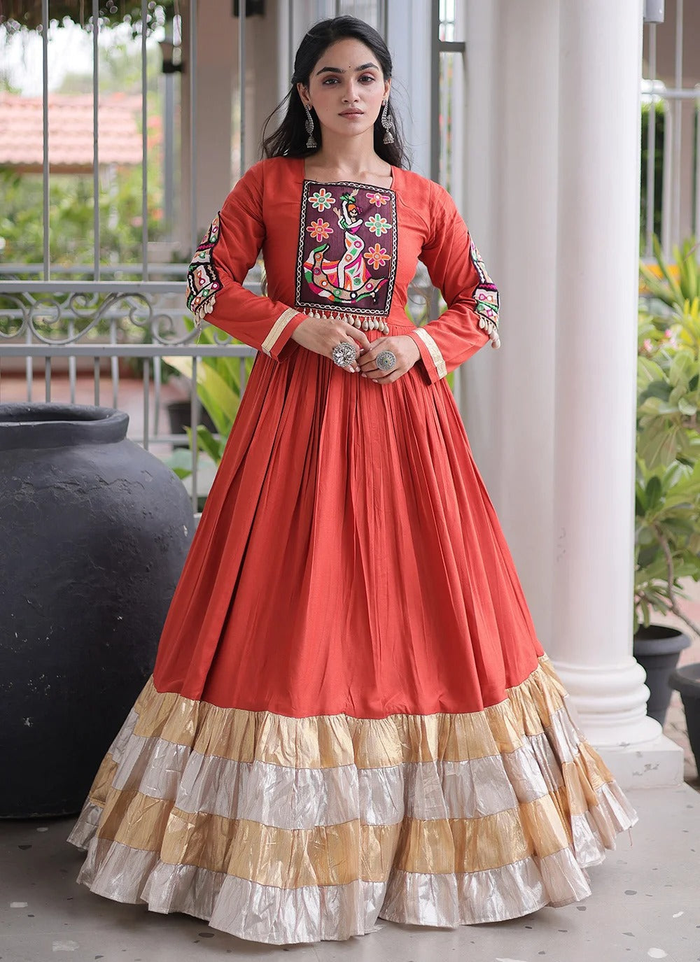 Rust color navratri gown with kutchi gamthi work and 12 meter flair