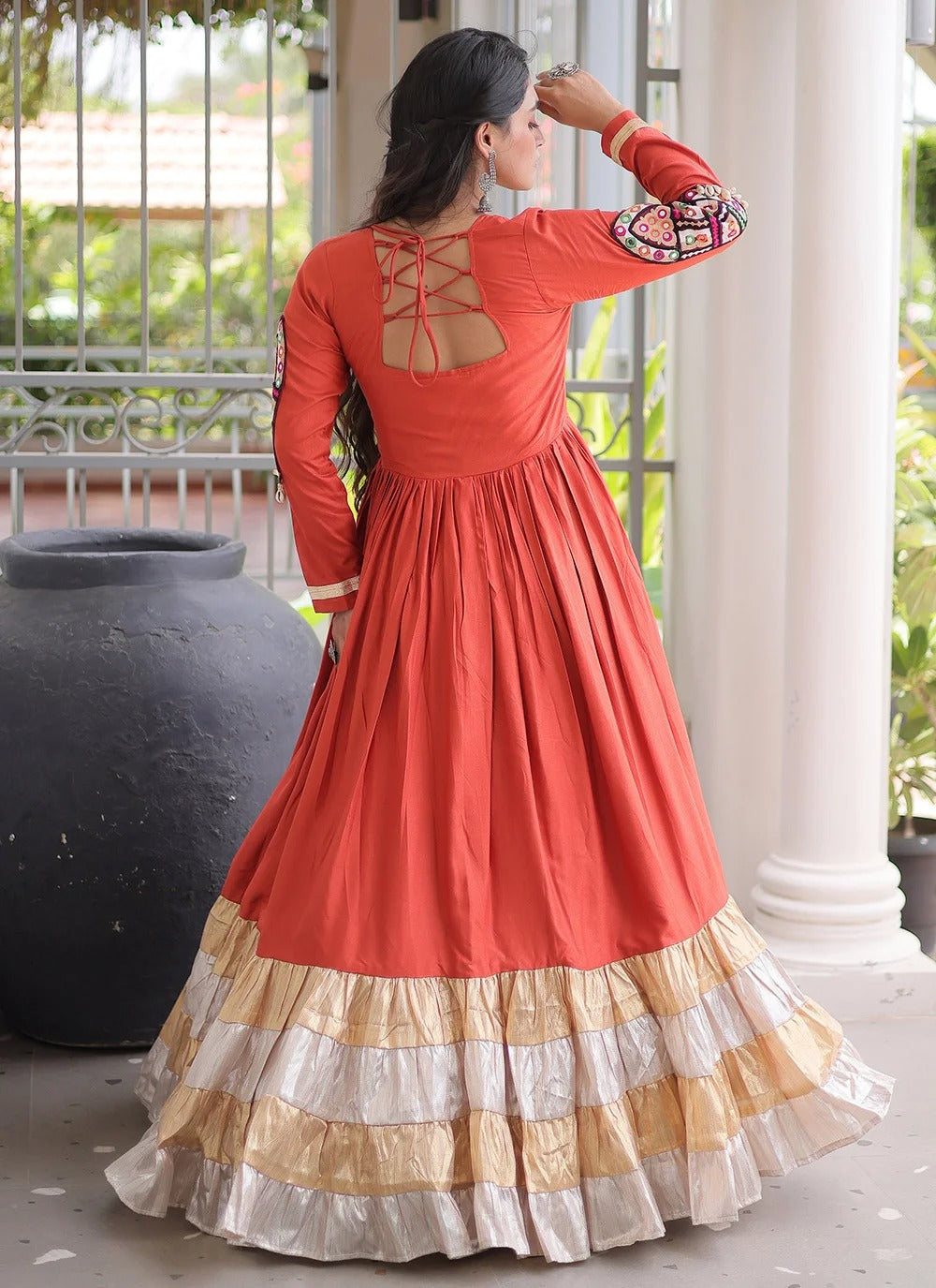 Rust color navratri gown with kutchi gamthi work and 12 meter flair