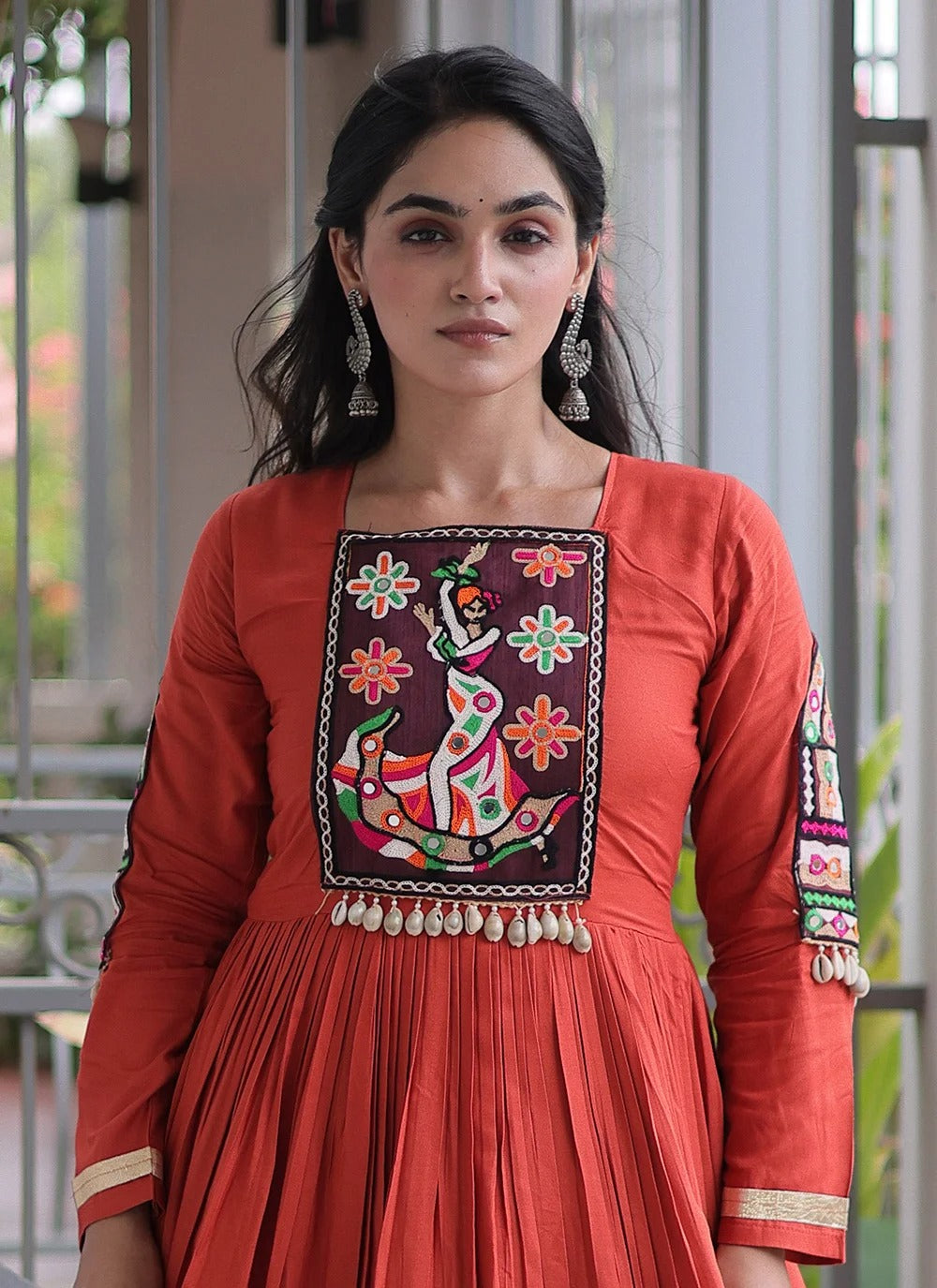 Rust color navratri gown with kutchi gamthi work and 12 meter flair