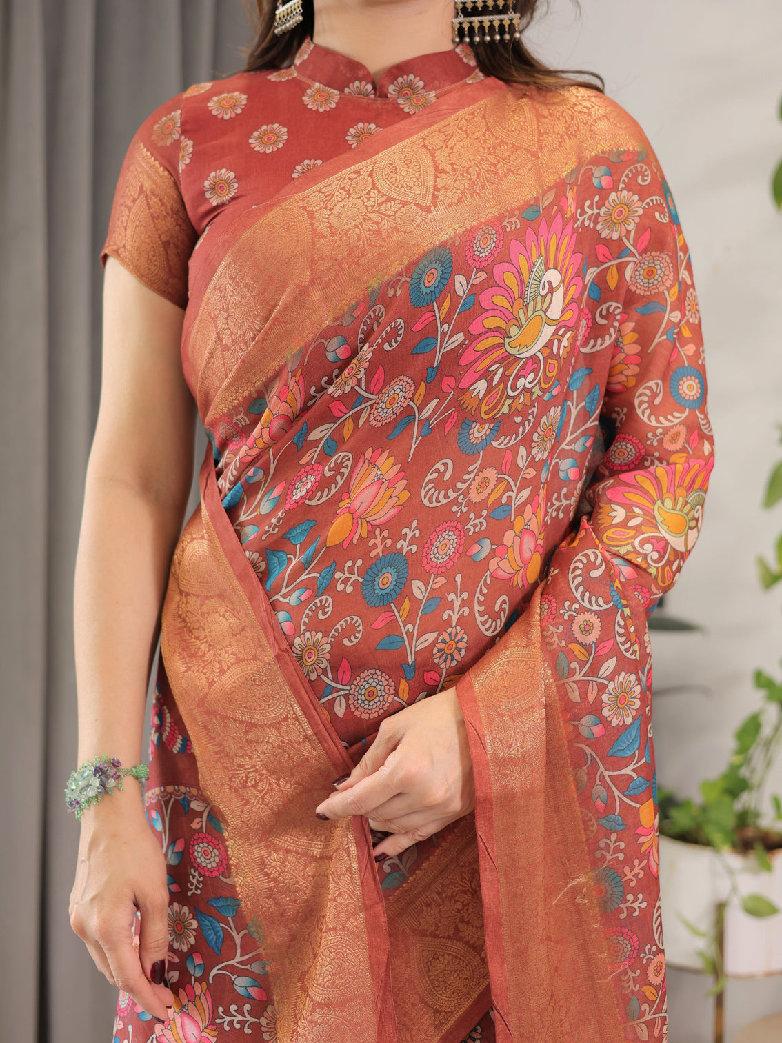 Graceful rust orange floral cotton linen saree with zari border tassels