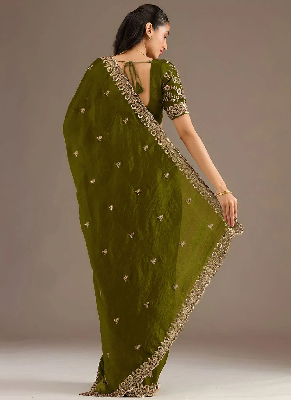 Sophisticated olive green designer tissue silk saree with zari sequins embroidery
