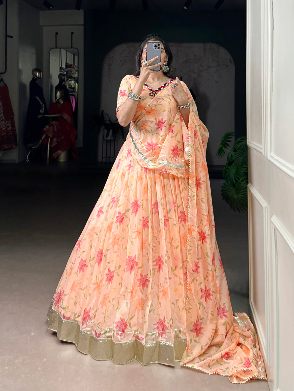 Peach tubby silk floral printed lehenga choli with embossed lace mirror work