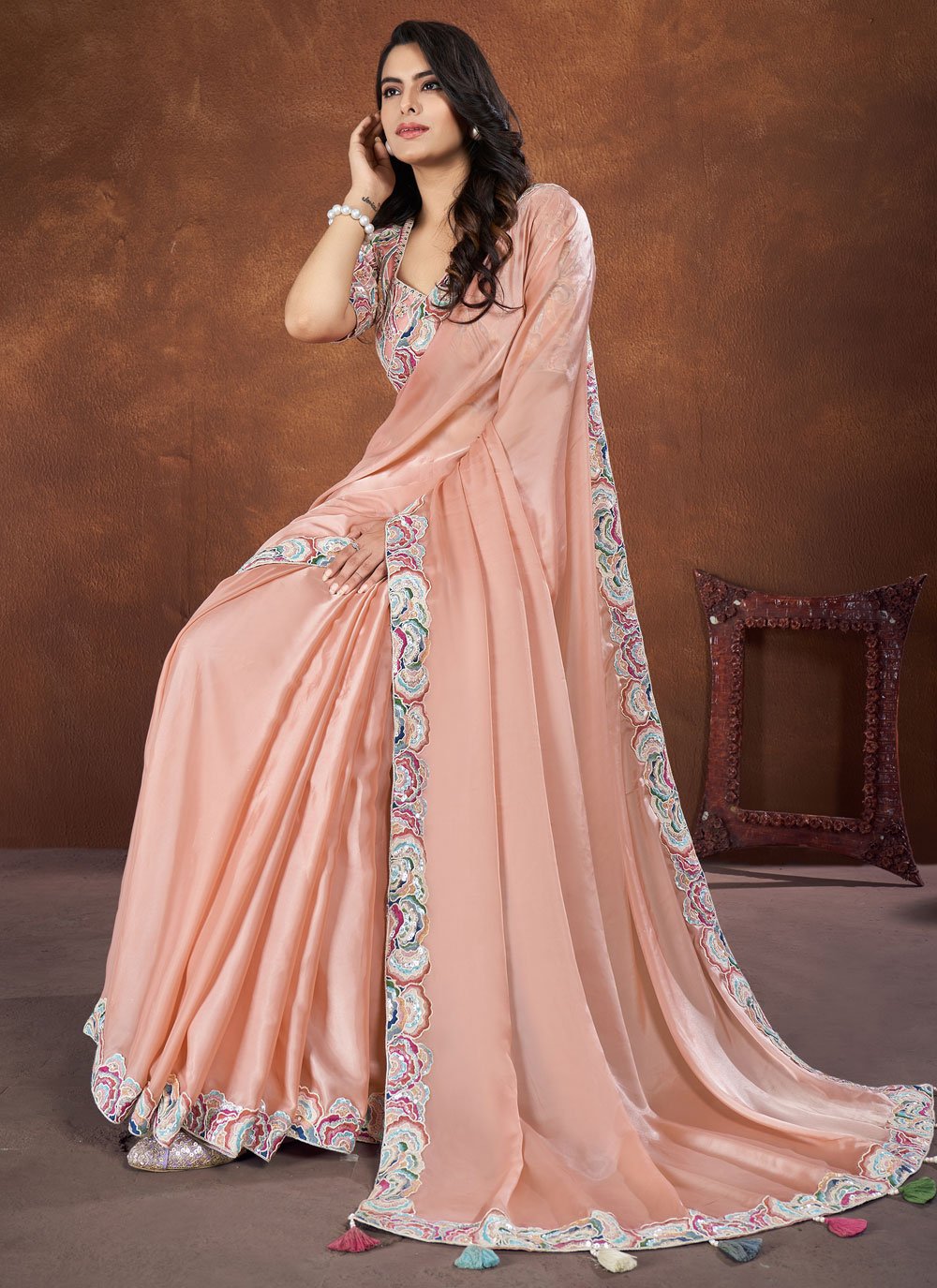 Peach embroidered crepe satin silk saree with net stitched blouse