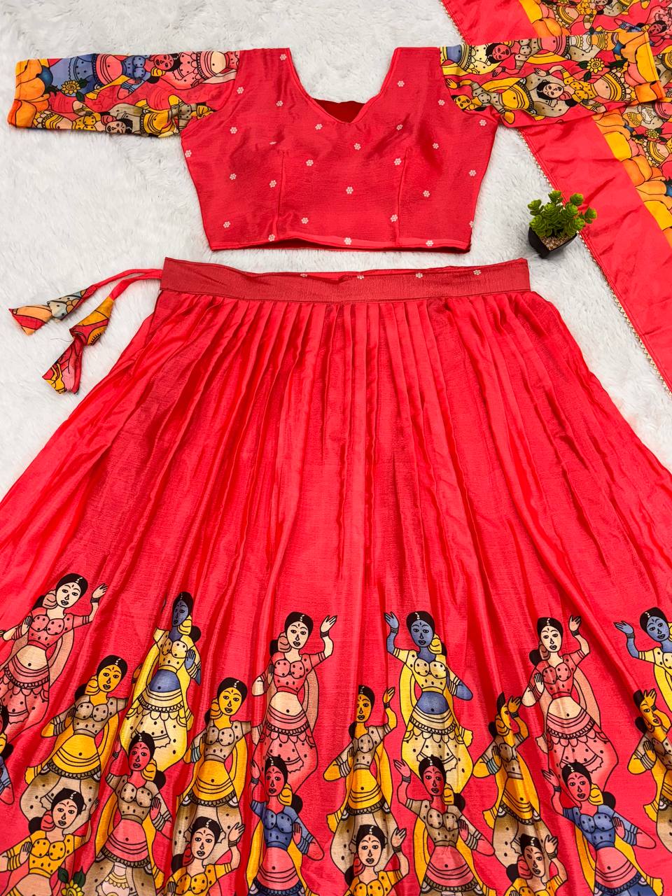 Bold red lehenga with vibrant folk dancer print and matching choli