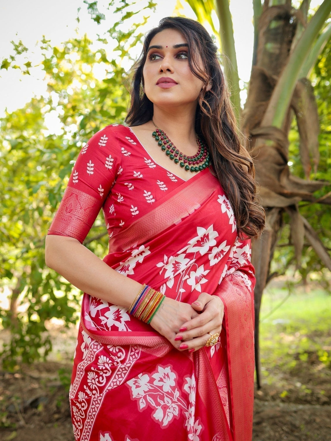 Graceful red tussar silk saree with white floral print zari border tassel pallu