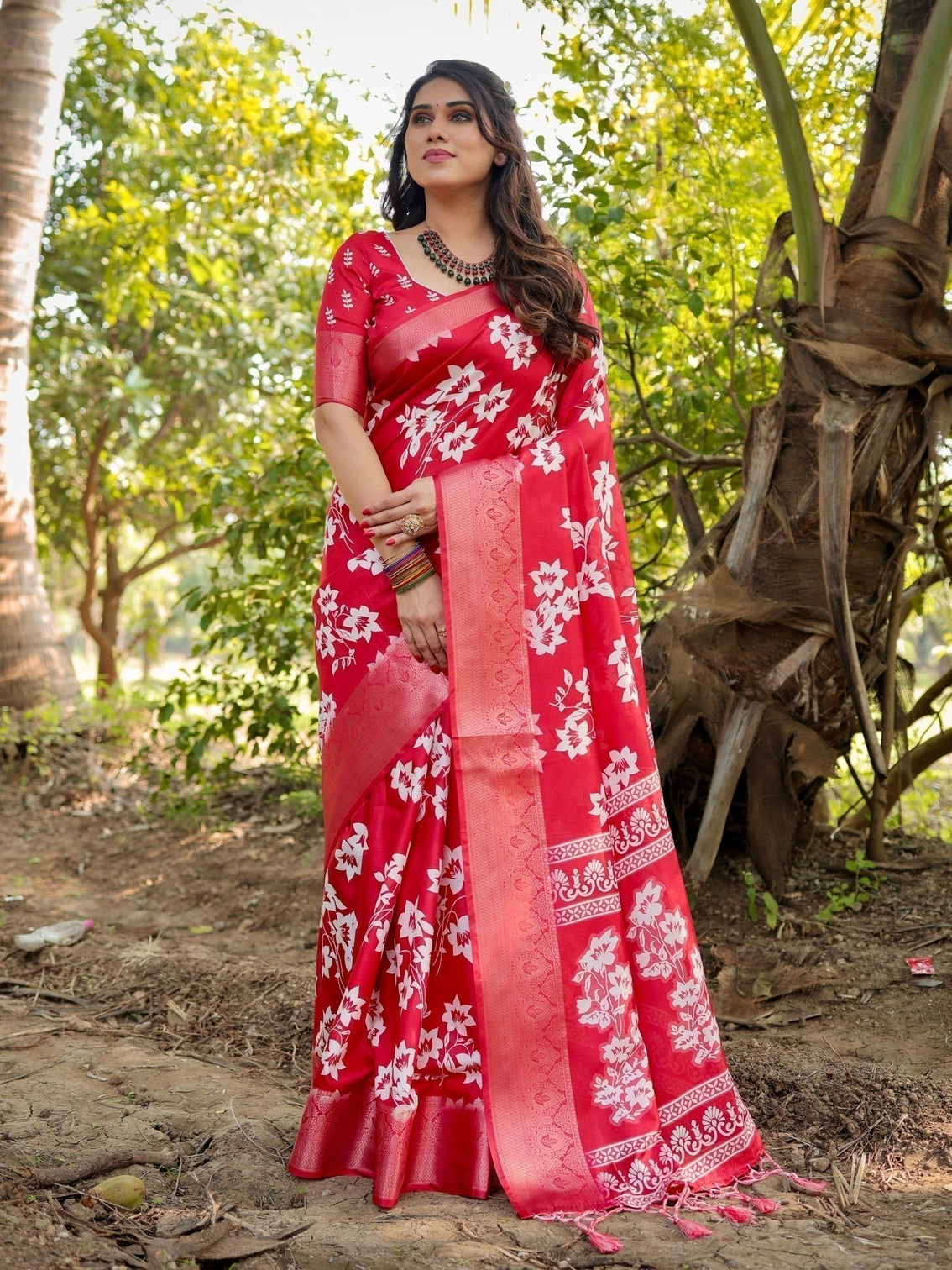 Graceful red tussar silk saree with white floral print zari border tassel pallu