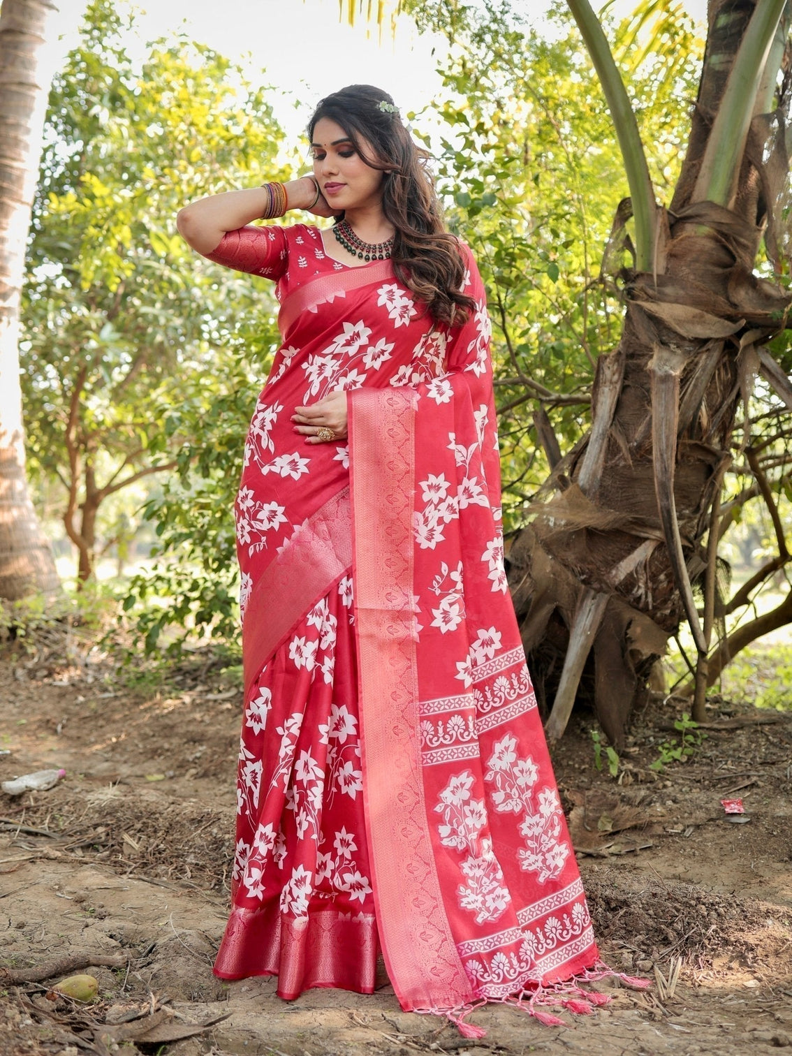 Graceful red tussar silk saree with white floral print zari border tassel pallu