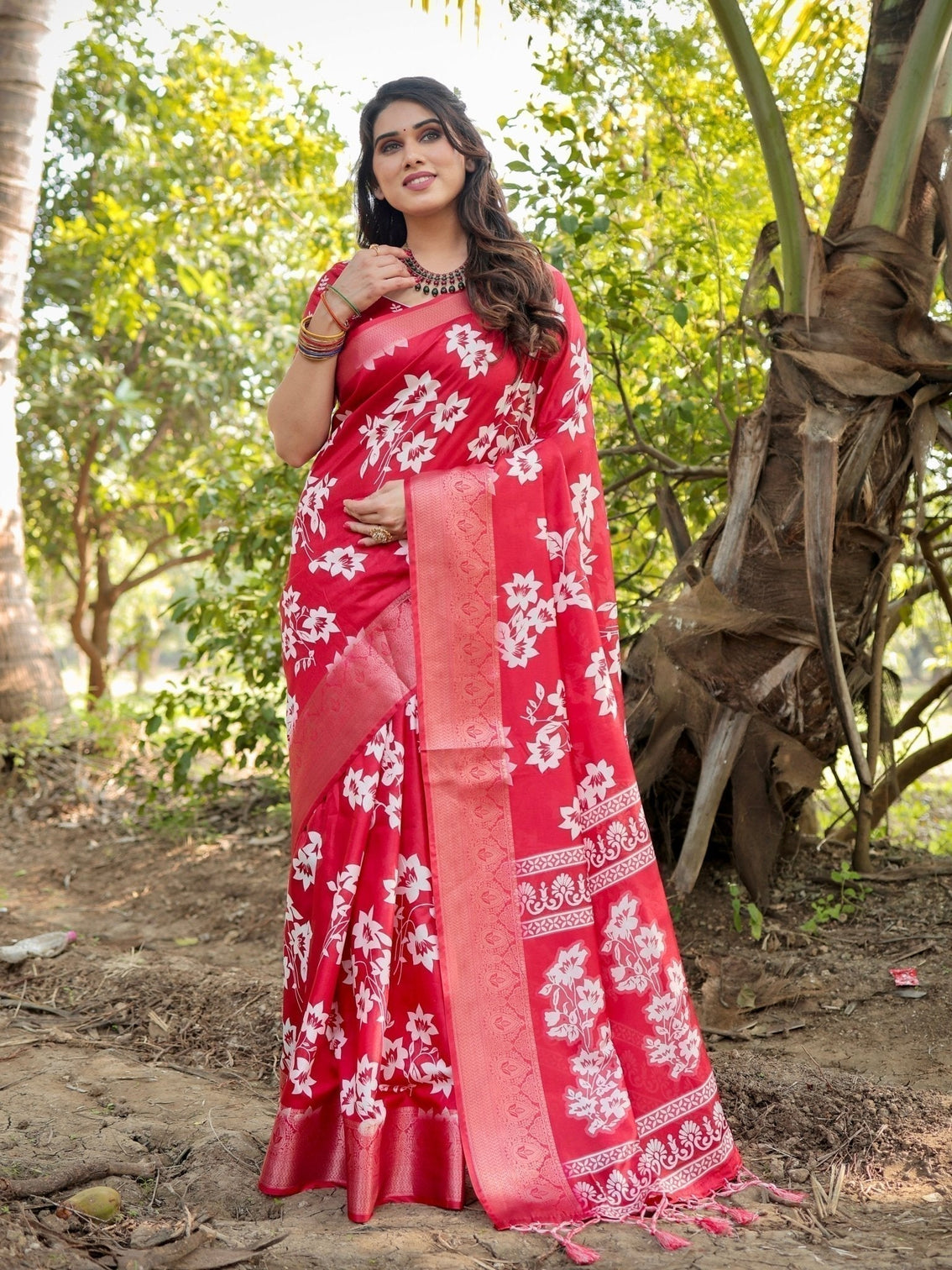 Graceful red tussar silk saree with white floral print zari border tassel pallu