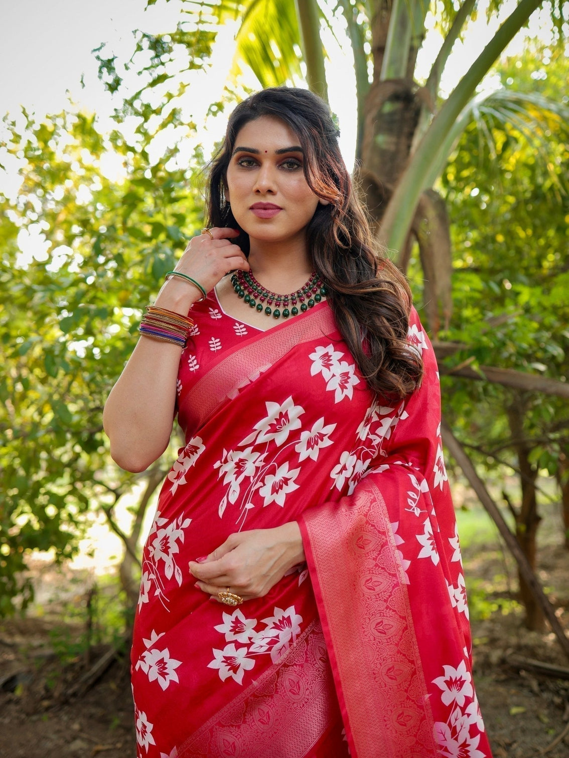Graceful red tussar silk saree with white floral print zari border tassel pallu