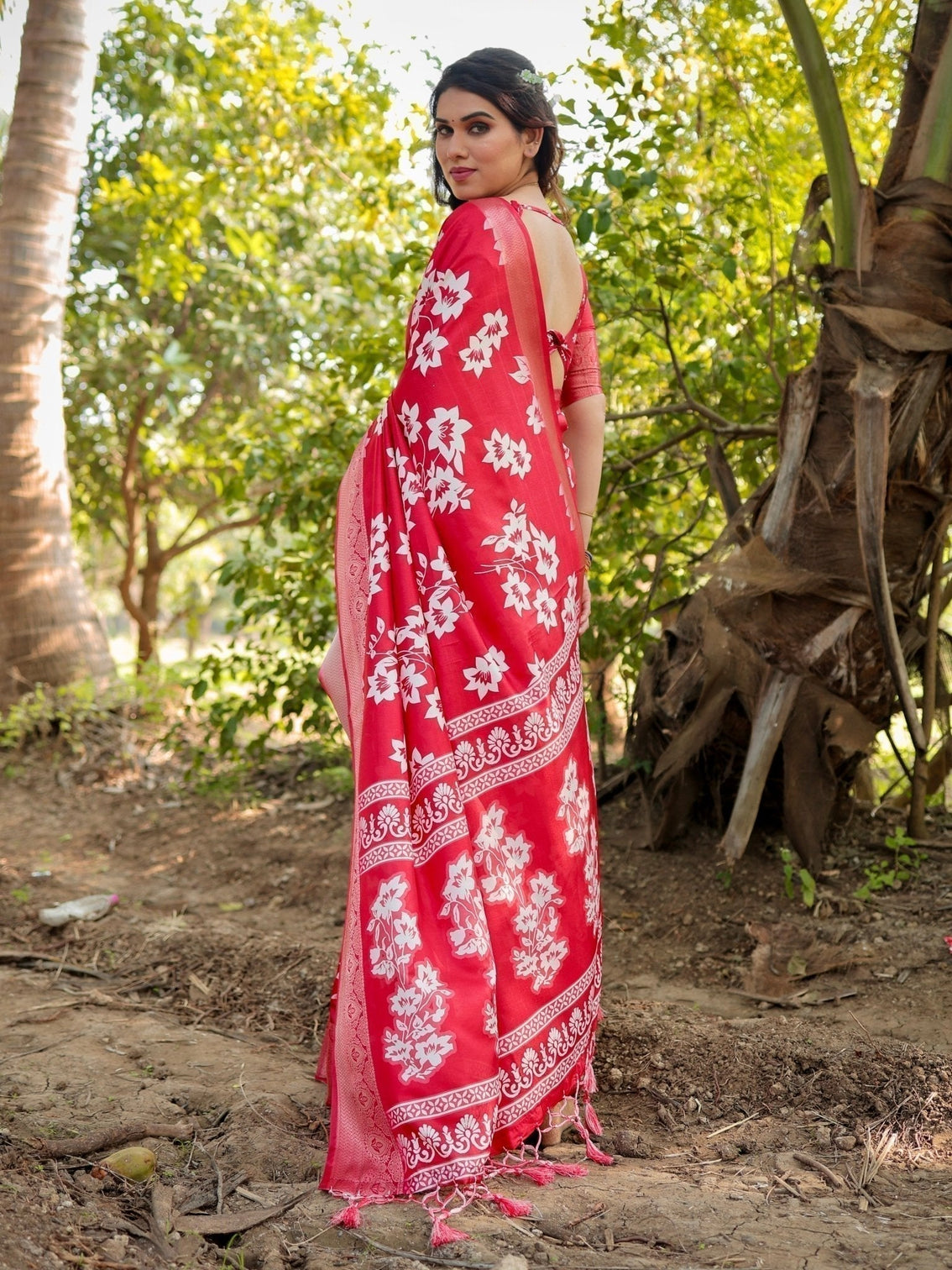 Graceful red tussar silk saree with white floral print zari border tassel pallu