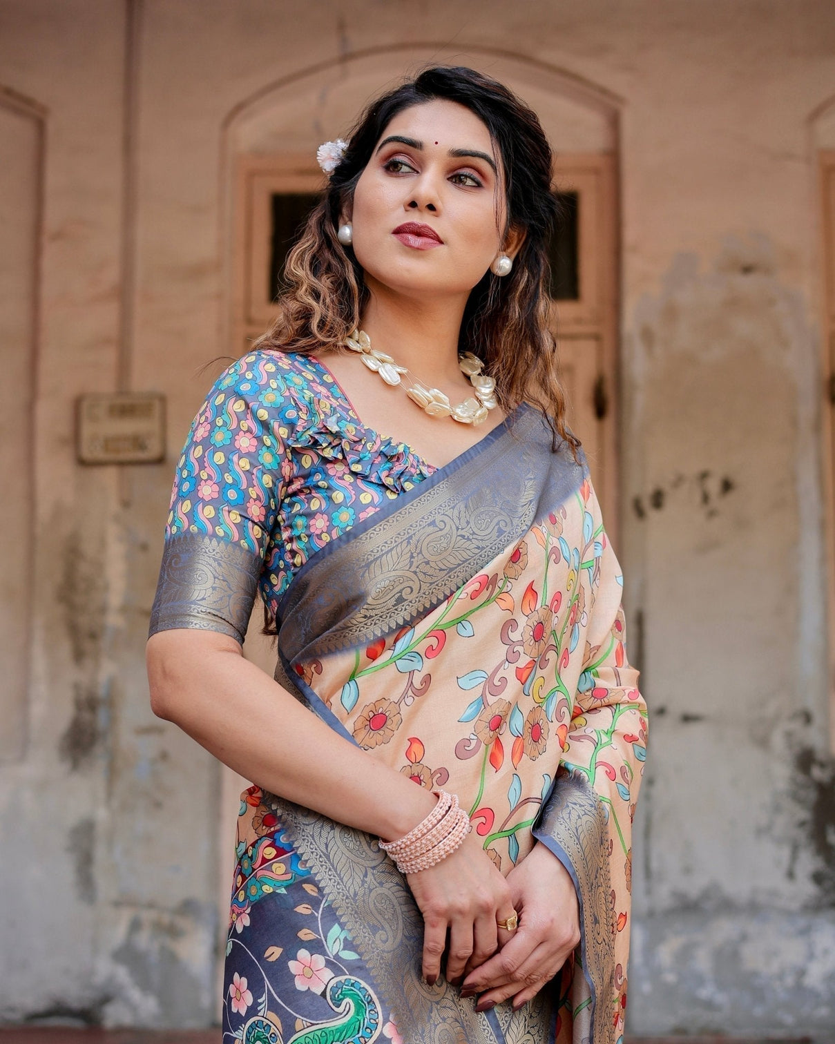 Peach and Navy Blue Floral Saree with Vibrant Peacock Pallu and Tassel Detailing