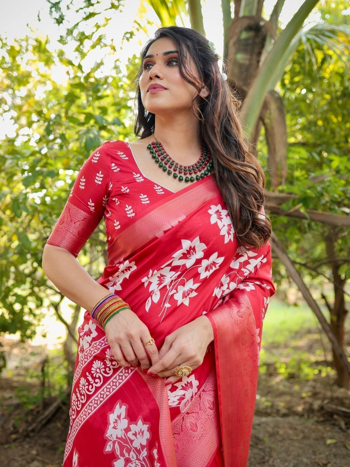 Graceful red tussar silk saree with white floral print zari border tassel pallu
