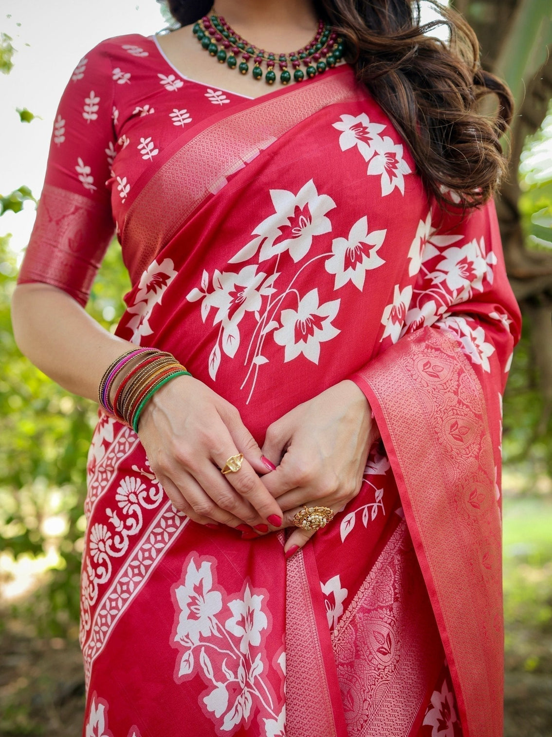 Graceful red tussar silk saree with white floral print zari border tassel pallu