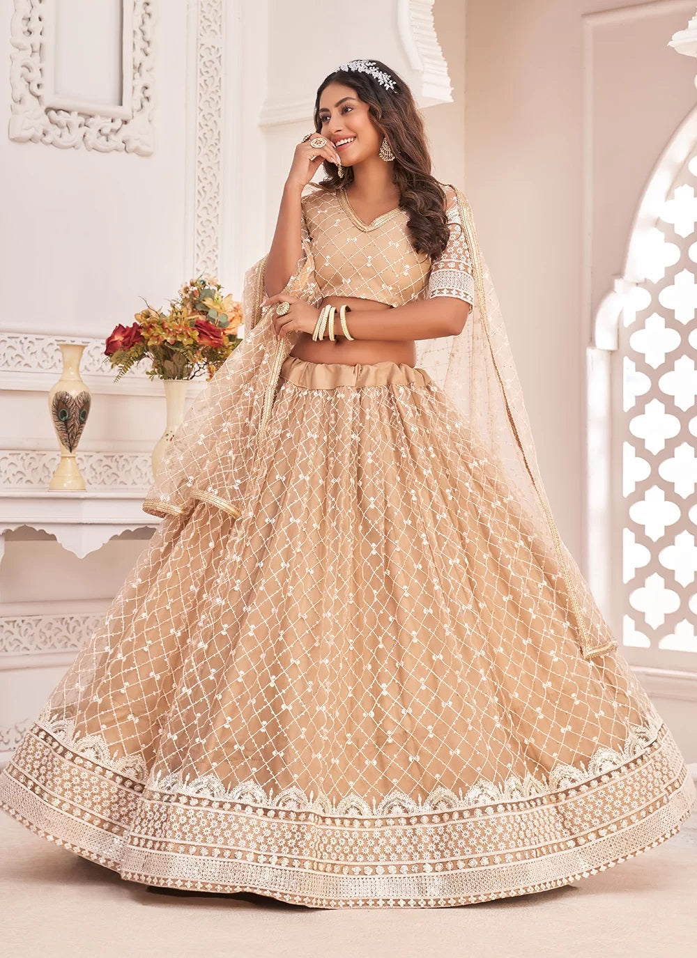 Sequence embroidered chikoo net party wear lehenga