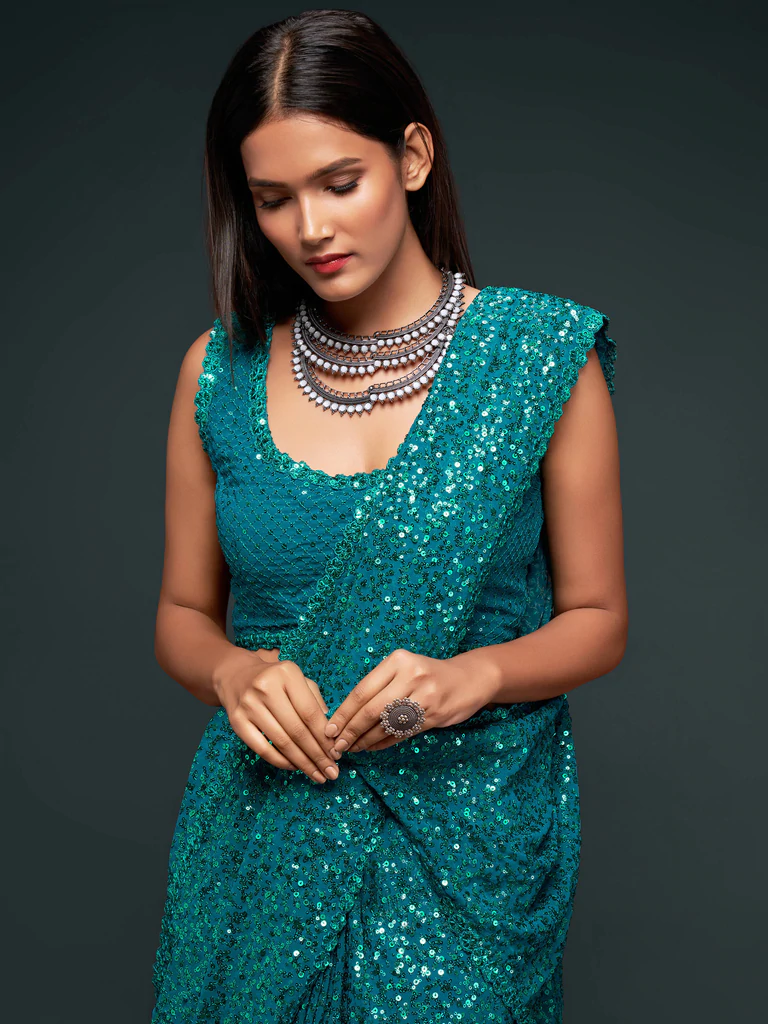 Sequinned georgette saree in teal blue