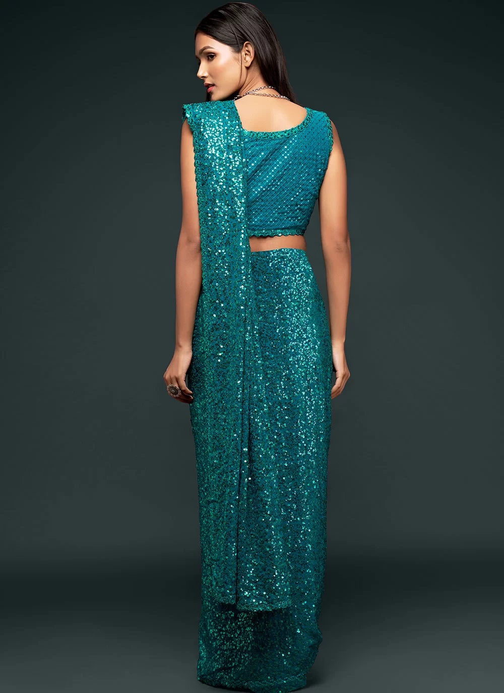 Sequinned georgette saree in teal blue