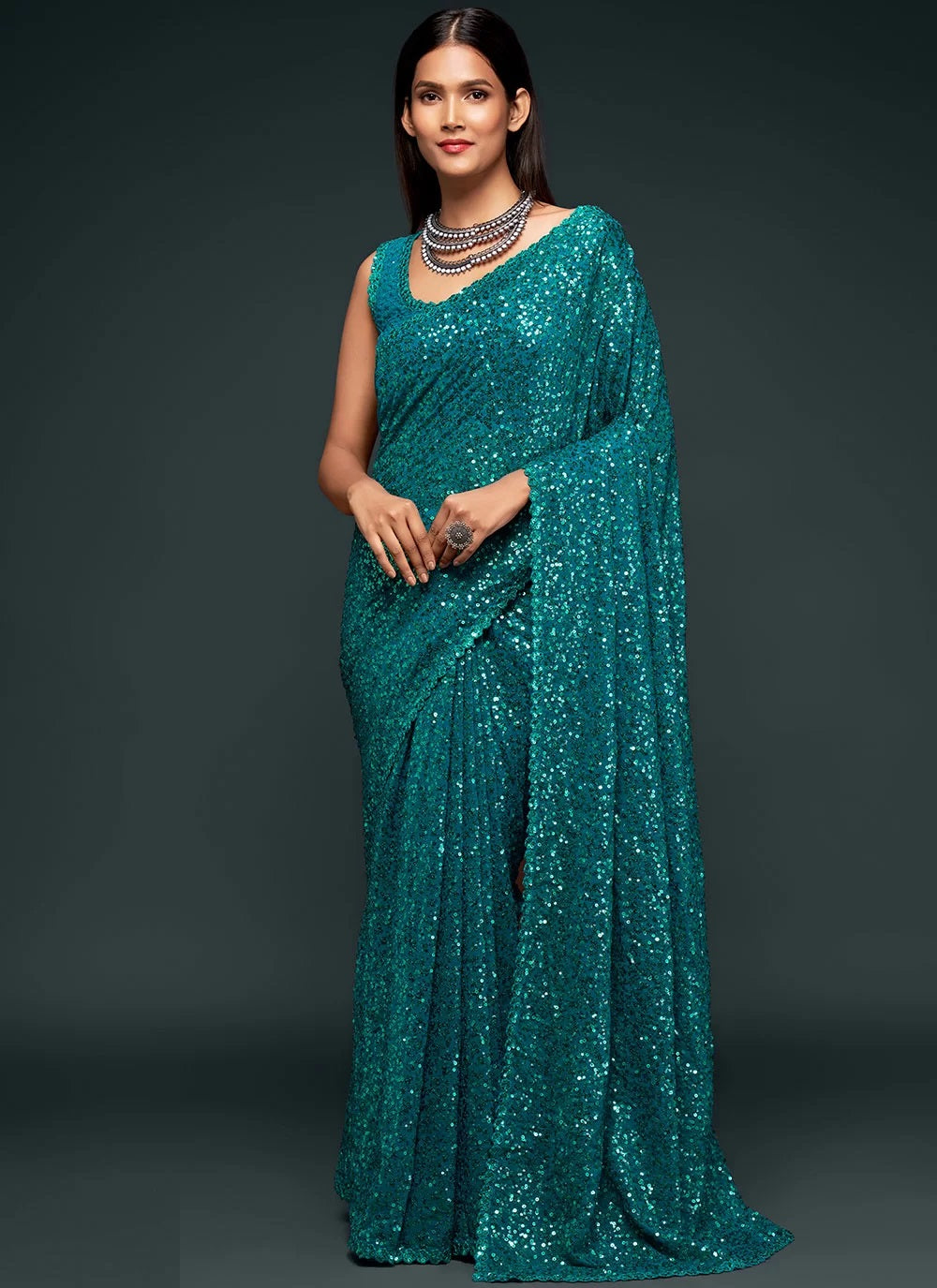 Sequinned georgette saree in teal blue