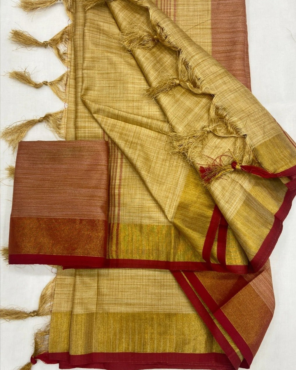 Elegant beige soft tissue saree with red border matching blouse piece