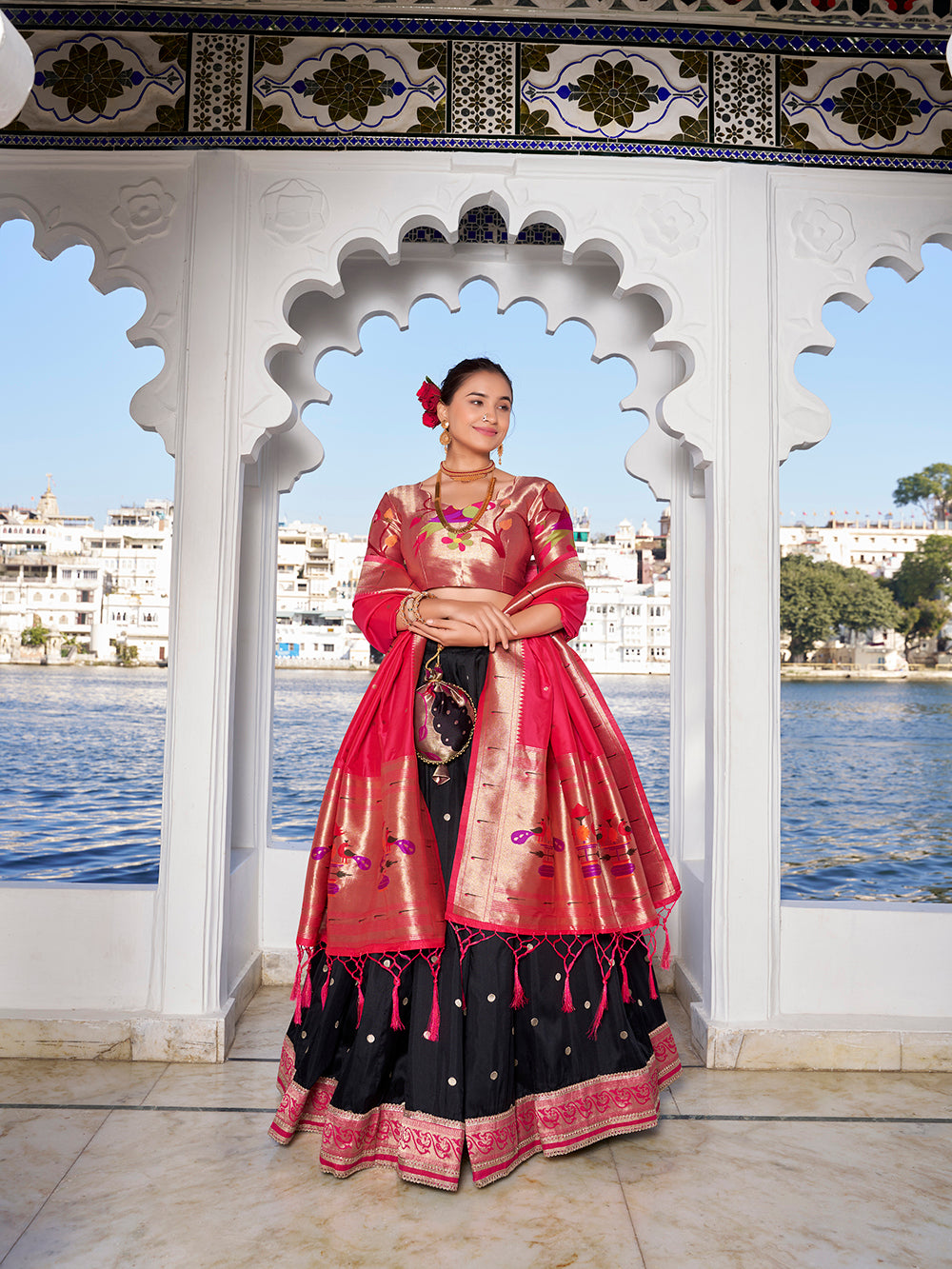 Elegant black jacquard silk lehenga choli with zari weaving matching potli purse
