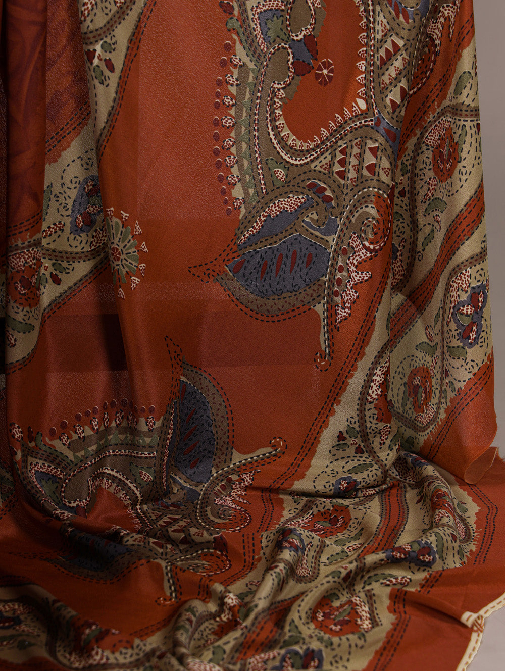 Rust orange crepe saree with all over print matching blouse