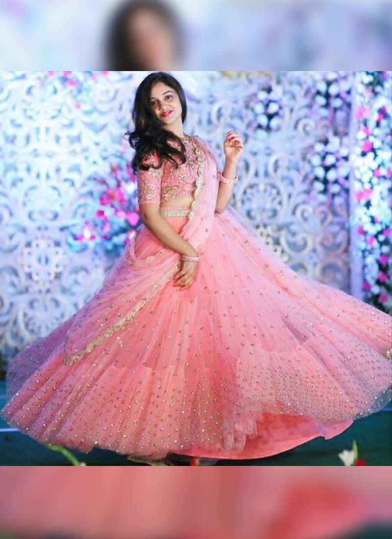 Unbeatable Peach Pink Soft Net Flared Sangeet Wear Lehenga Choli