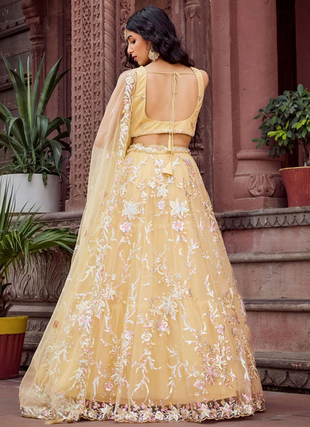 Bright yellow net haldi ceremony lehenga choli with embroidery