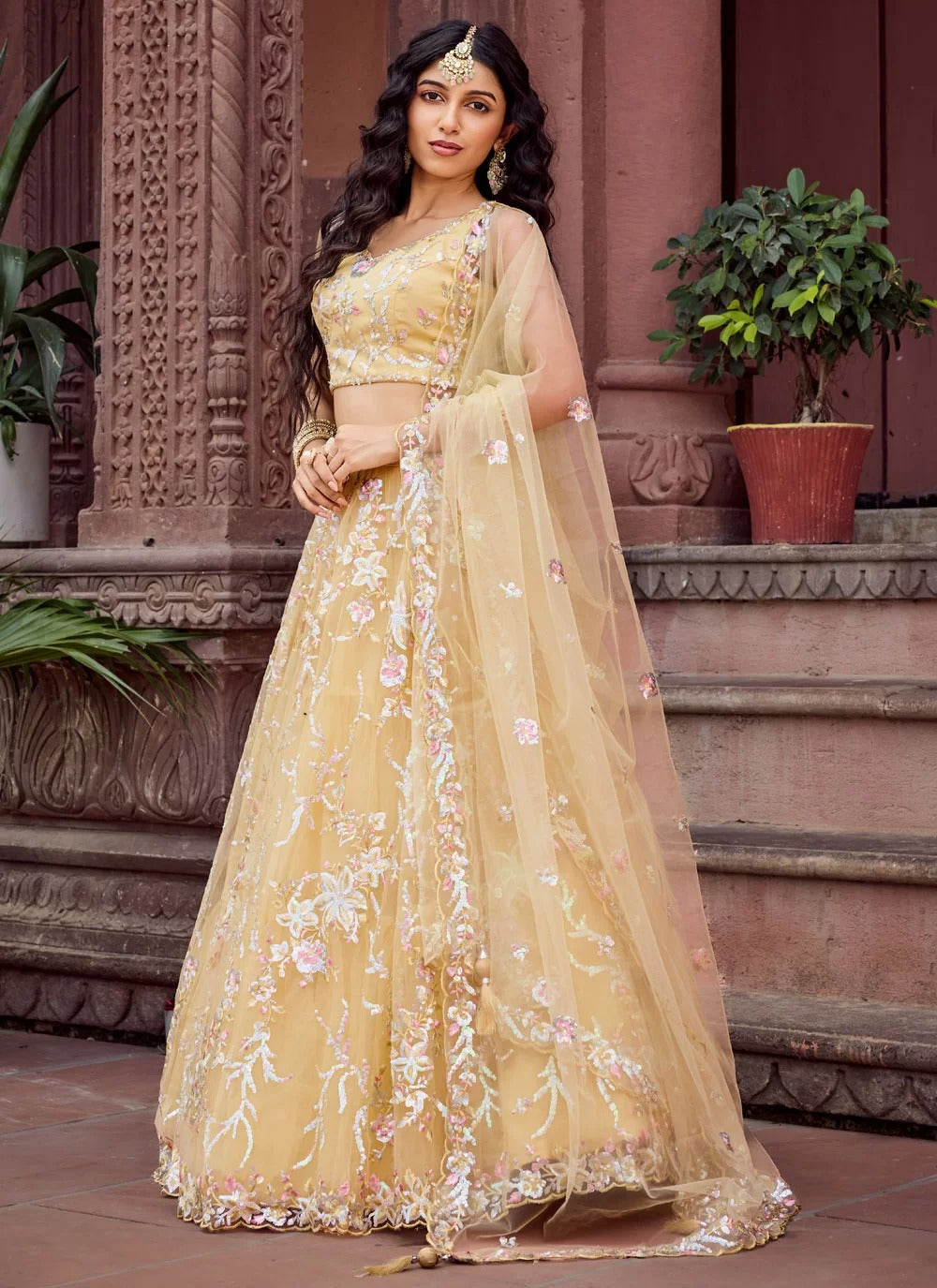 Bright yellow net haldi ceremony lehenga choli with embroidery